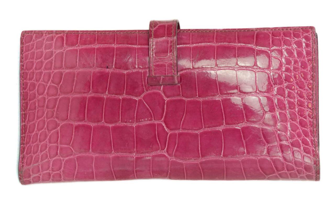 Hermes Alligator Rose Tyrien Pink H Bearn Wallet w/ Palladium Hardware

-Made in: France
-Year of Production: 2005
-Color: Rose tryrien pink
-Materials: Glazed alligator, metal
-Hardware: Palladium
-Lining: Pink chevre leather
-Exterior