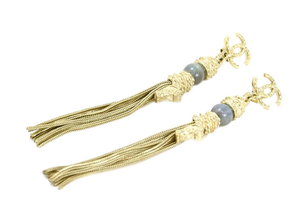 Features grey marbalized bead and multi-strand tassel

-Made in: France
-Year of Production: 2010
-Stamp: CHANEL 10 A MADE IN FRANCE
-Color: Brushed goldtone
-Materials: Metal
-Overall Condition: Excellent

Measurements:
Total length: