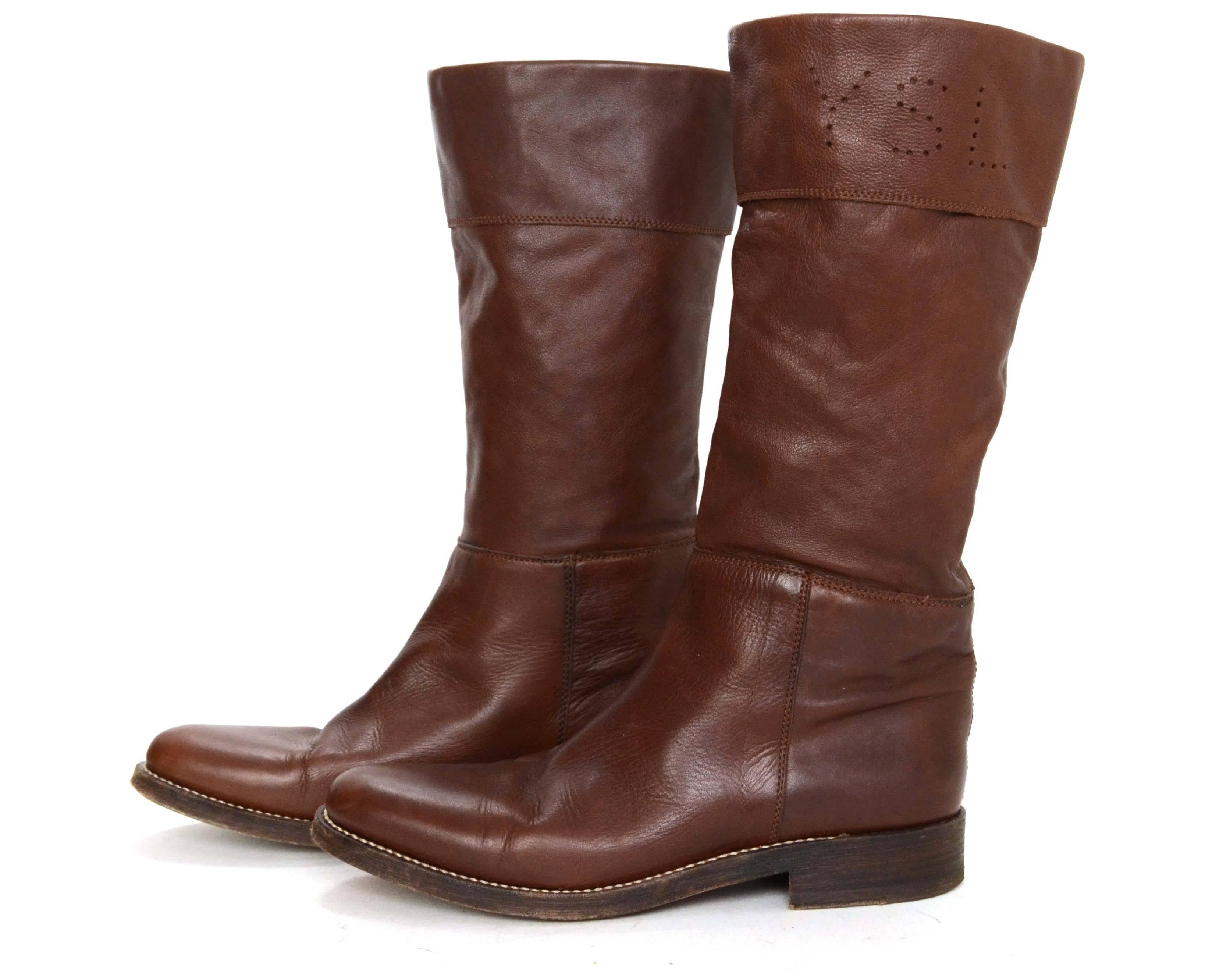 Yves Saint Laurent YSL Brown Leather Boots 
Features perforated logo on top side
Made In: Spain
Color: Brown
Composition: Leather
Closure/Opening: Pull on
Sole Stamp: Yves Saint Laurent a rive gauche Made in Spain Cuir Veritable 40