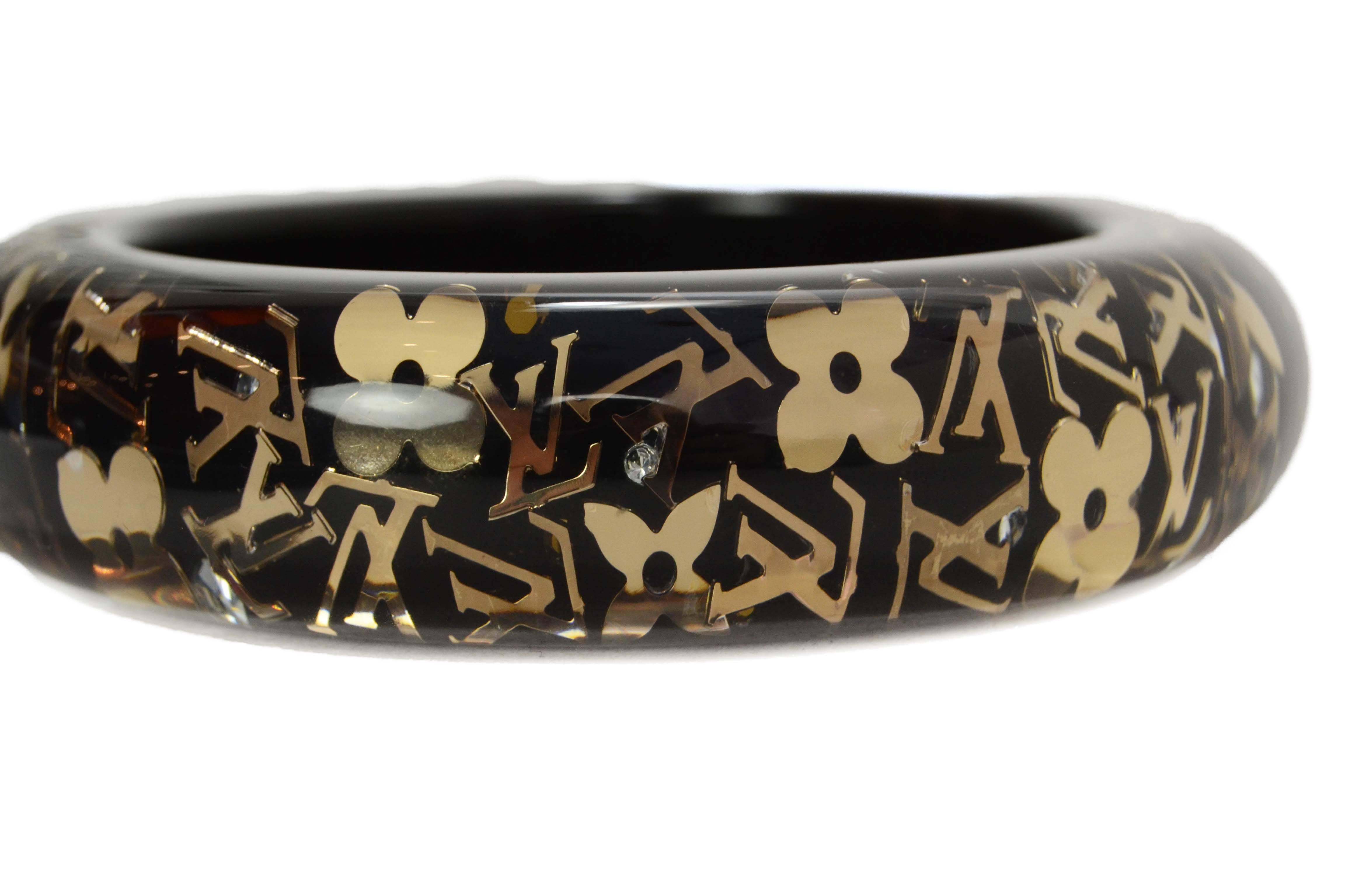 Louis Vuitton Black & Gold Resin Logo Bangle 
Features little rhinestones throughout
Color: Black, goldtone and clear
Materials: Resin, metal and rhinestones
Closure: None
Retail Price: $475 + tax
Overall Condition: Excellent pre-owned