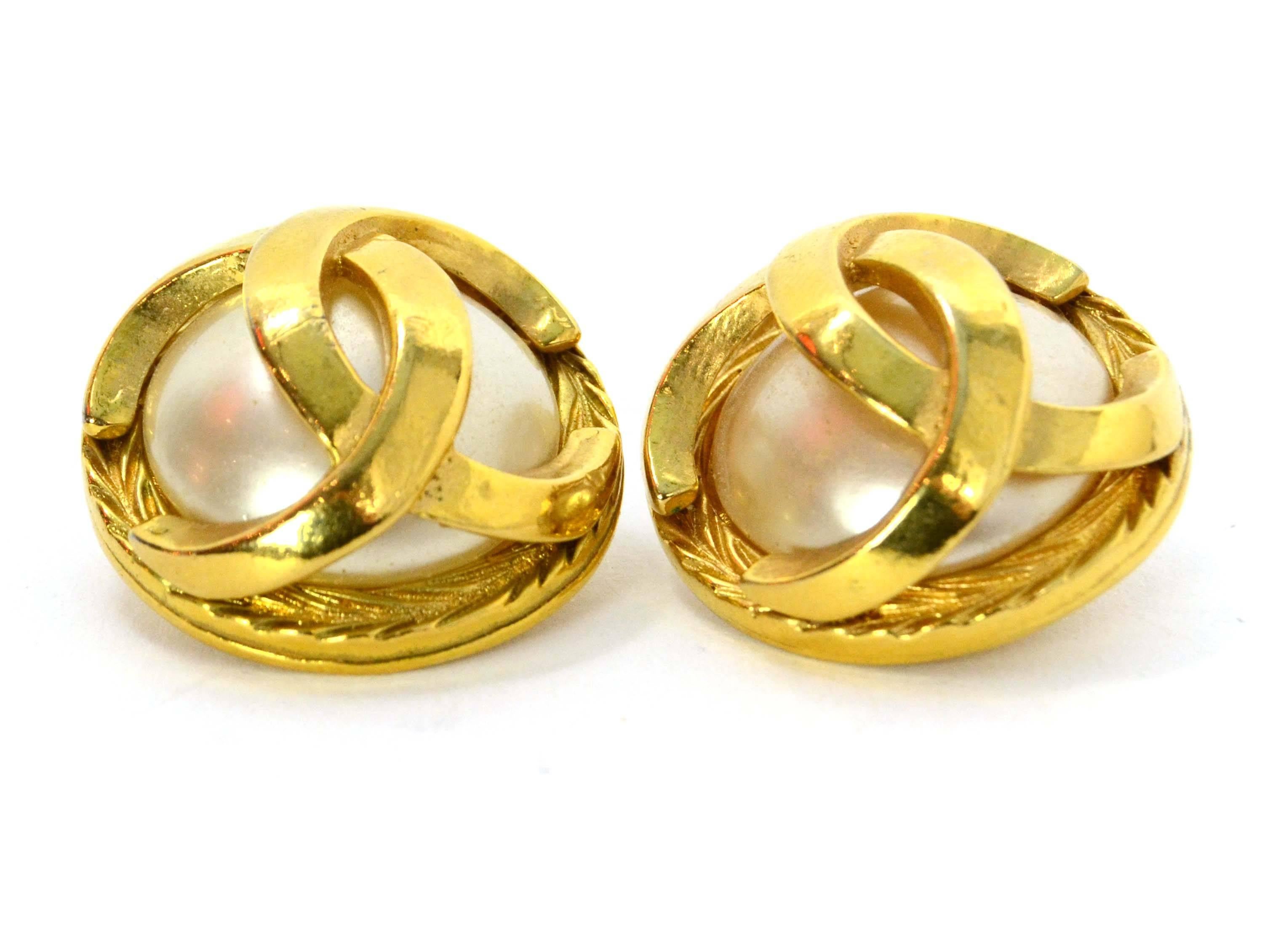 Chanel Vintage '70s Pearl & Gold Clip On Earrings 
Features goldtone CC overlay
Made In: France
Year of Production: 1970's
Color: Ivory and goldtone
Materials: Faux pearl and metal
Closure: Clip on 
Stamp: Chanel CC Made in France
Overall