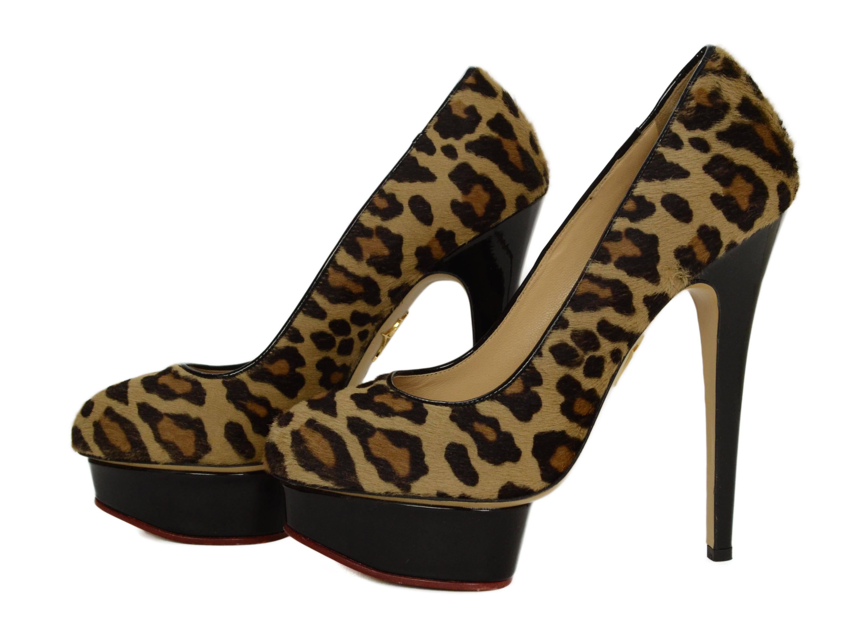 Charlotte Olympia Leopard Print Ponyhair Platform Pumps 
Features black patent covered heel and platform
Made In: Italy
Color: Brown and black leopard print
Materials: Patent leather and ponyhair
Closure: Slide on
Sole Stamp: Vero Cuoio Made