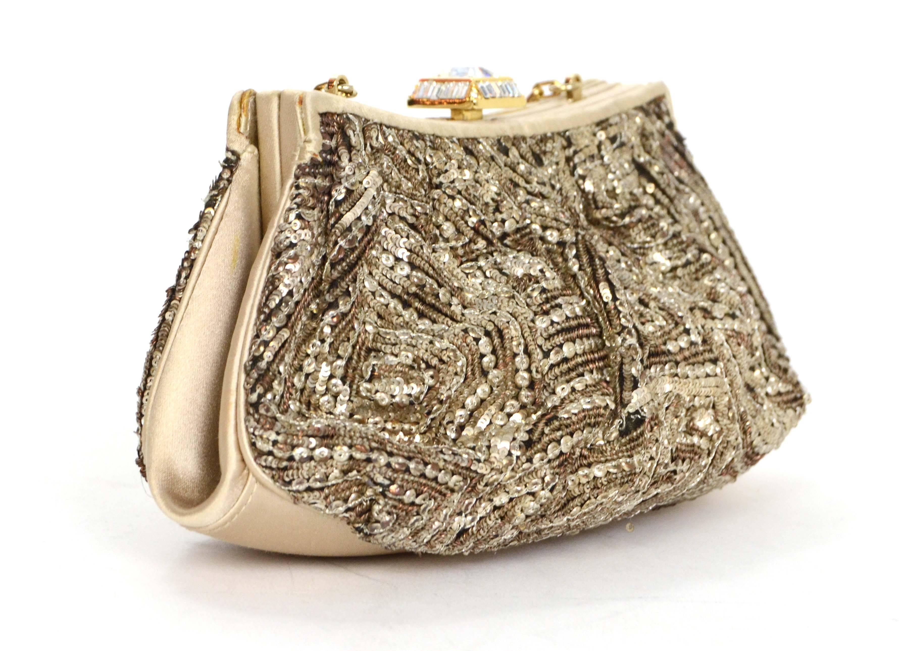 Judith Leiber Pewter Sequin Evening Bag 
Features crystal embellished top lever and shoulder strap
Made In: Italy
Color: Pewter and champagne 
Hardware: Goldtone
Materials: Sequins, satin, crystal and metal
Lining: Purple