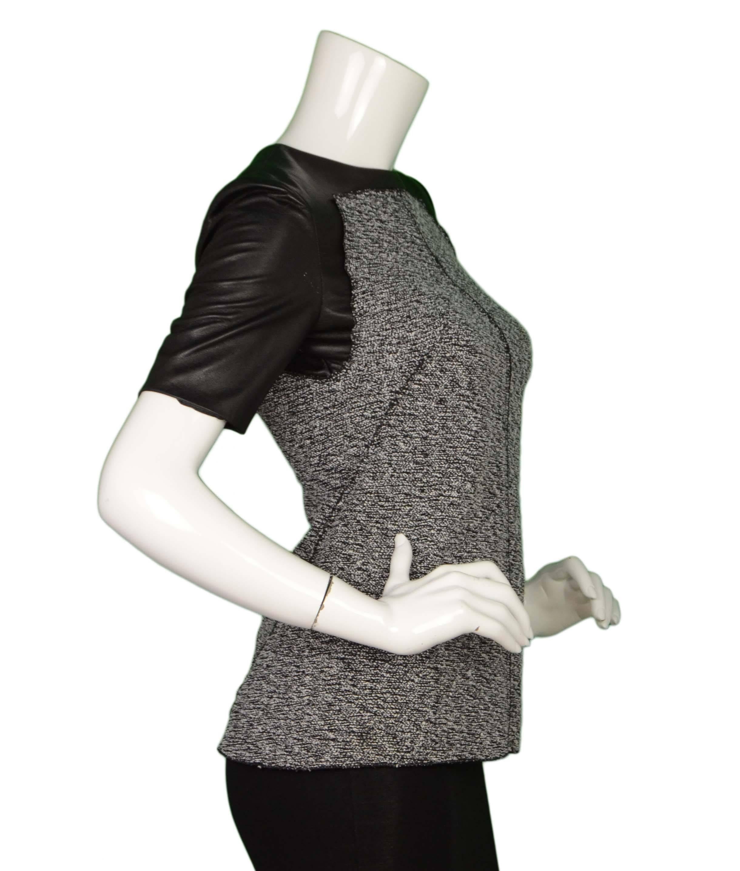 Proenza Schouler Black Leather & Tweed Short Sleeve Top 
Features black leather sleeves with black and white tweed bodice
Color: Black and white
Composition: Not given- bodice believed to be tweed-wool blend and sleeves believed to be 100%