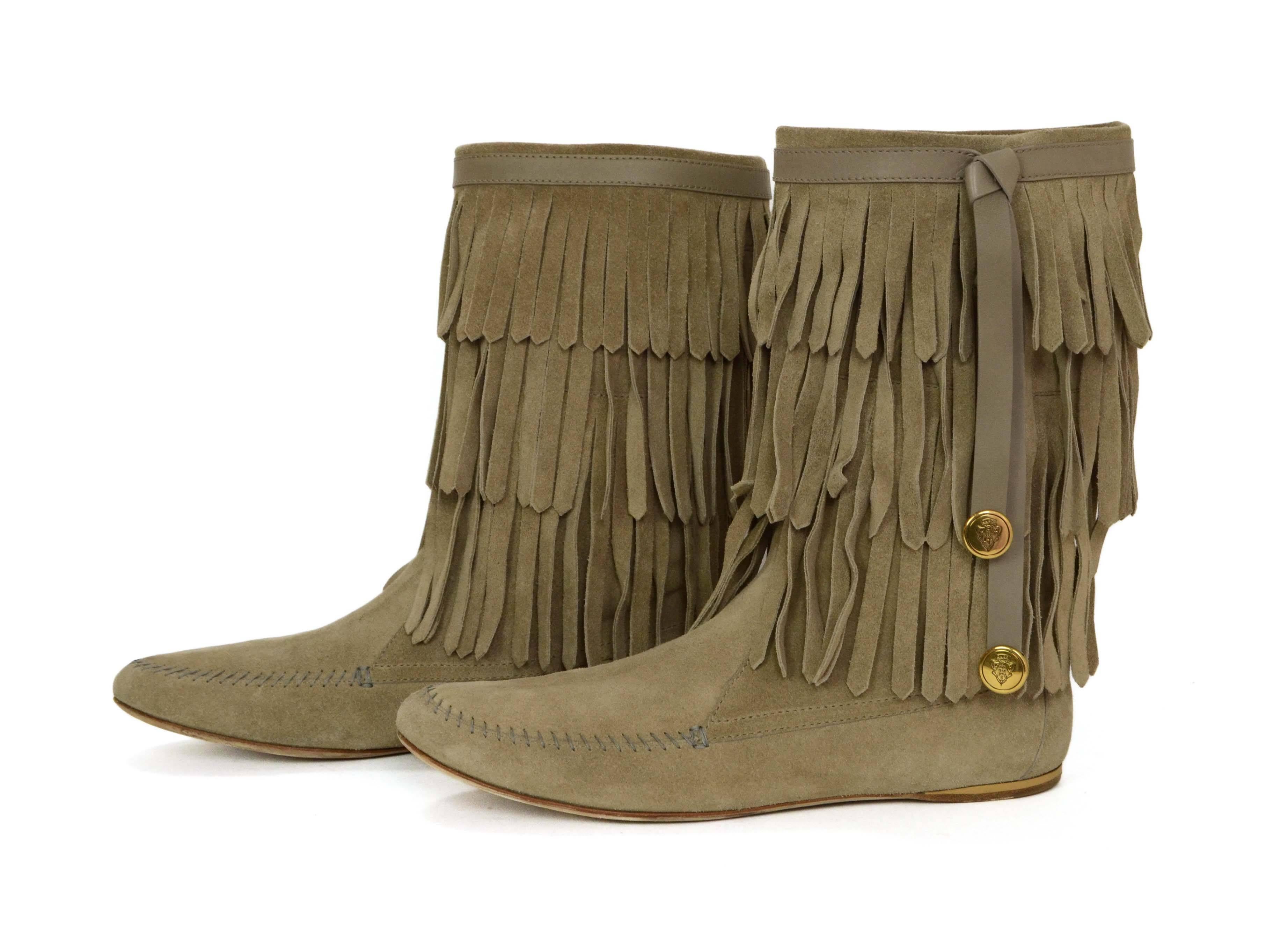 Gucci Beige Suede Fringe Boots 
Features leather tabs on boot top with goldtone coins attached and Gucci logo
Made In: Italy
Color: Beige
Materials: Suede
Closure/Opening: Pull on
Sole Stamp: Gucci Made in Italy 39C
Overall Condition: