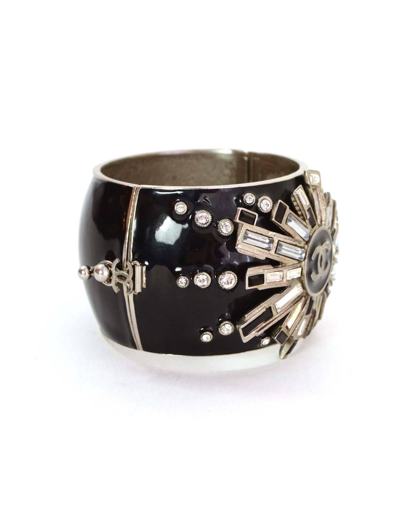 Chanel Black & Crystal Starburst Cuff 
Features large CC in center
Made In: France
Year of Production: 2005
Color: Black, silvertone and clear
Materials: Metal, enamel, and crystal
Closure: Magnetic hinge closure with metal lever to secure