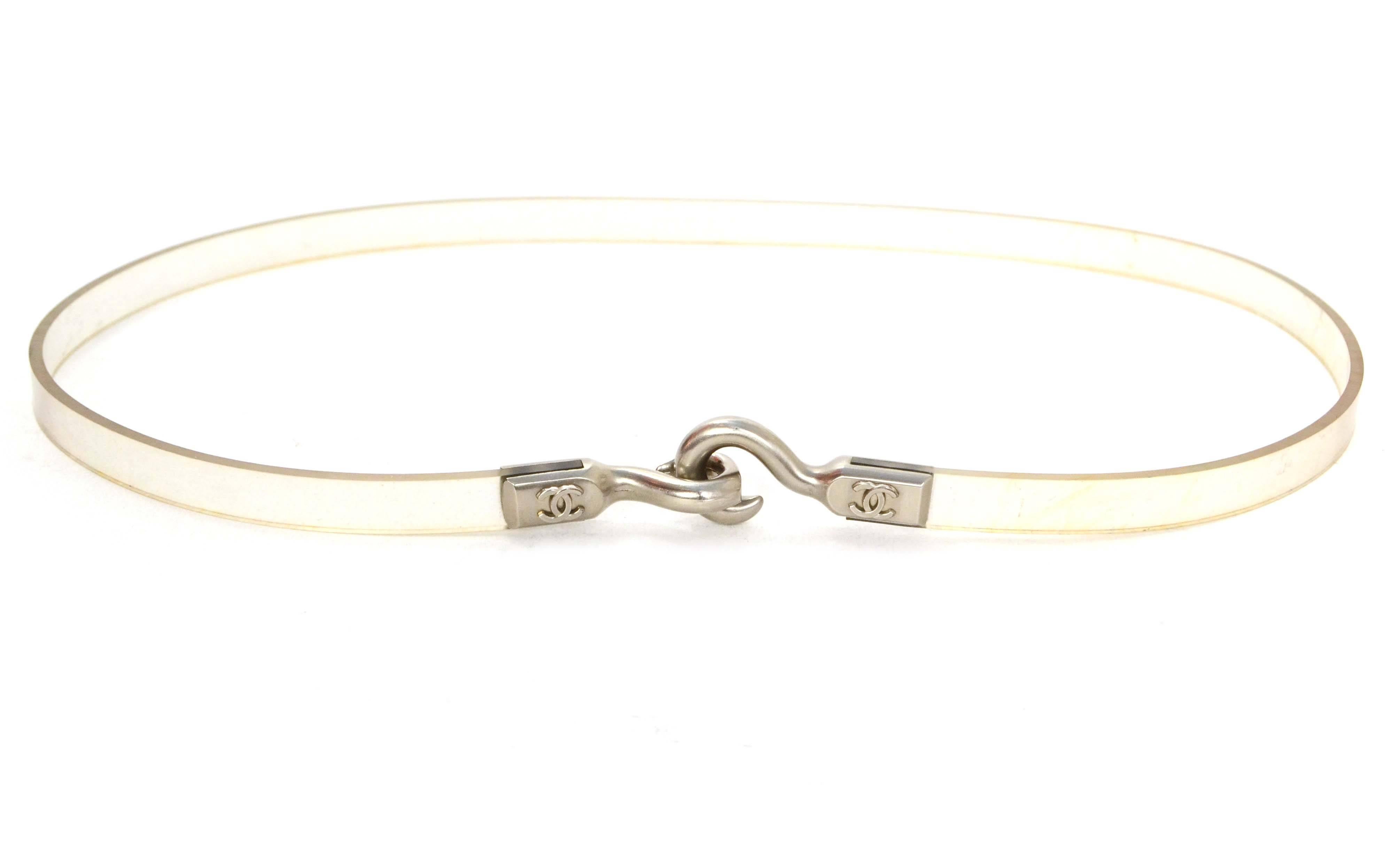 Chanel Clear Plastic Thin Belt 
Features CC on each hook
Color: Clear and silvertone
Hardware: Silvertone
Materials: Plastic and metal
Closure: Double hook closure
Overall Condition: Very good pre-owned condition with the exception of some