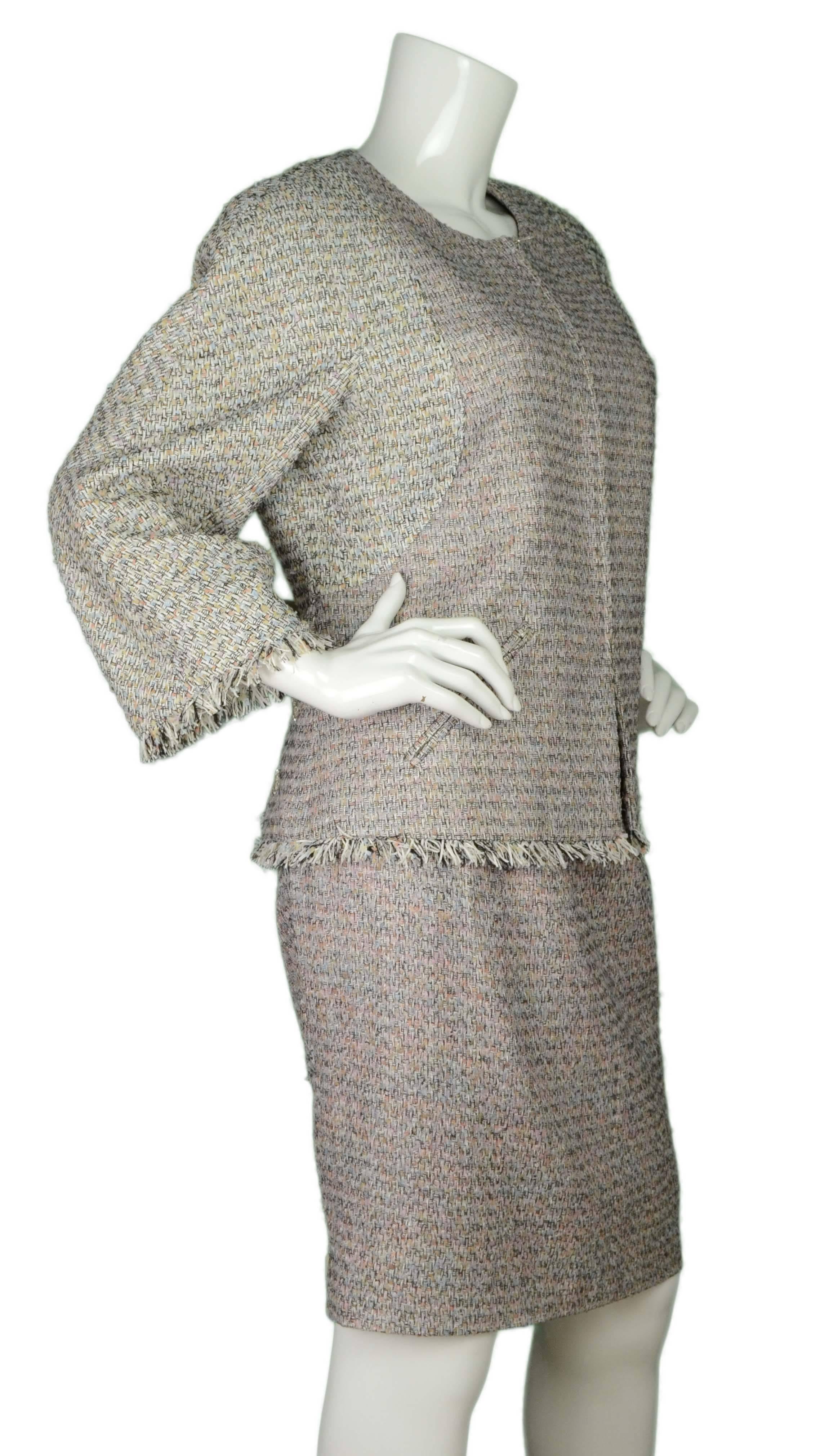 Chanel Multi-Colored Tweed Skirt Suit 
Features raw fringe at hemline of jacket sleeves and bottom of jacket
Made In: France
Color: Black, white, pale pink, pale blue, pale yellow
Composition: 62% cotton, 33% nylon, 5% rayon
Lining: White, 100%
