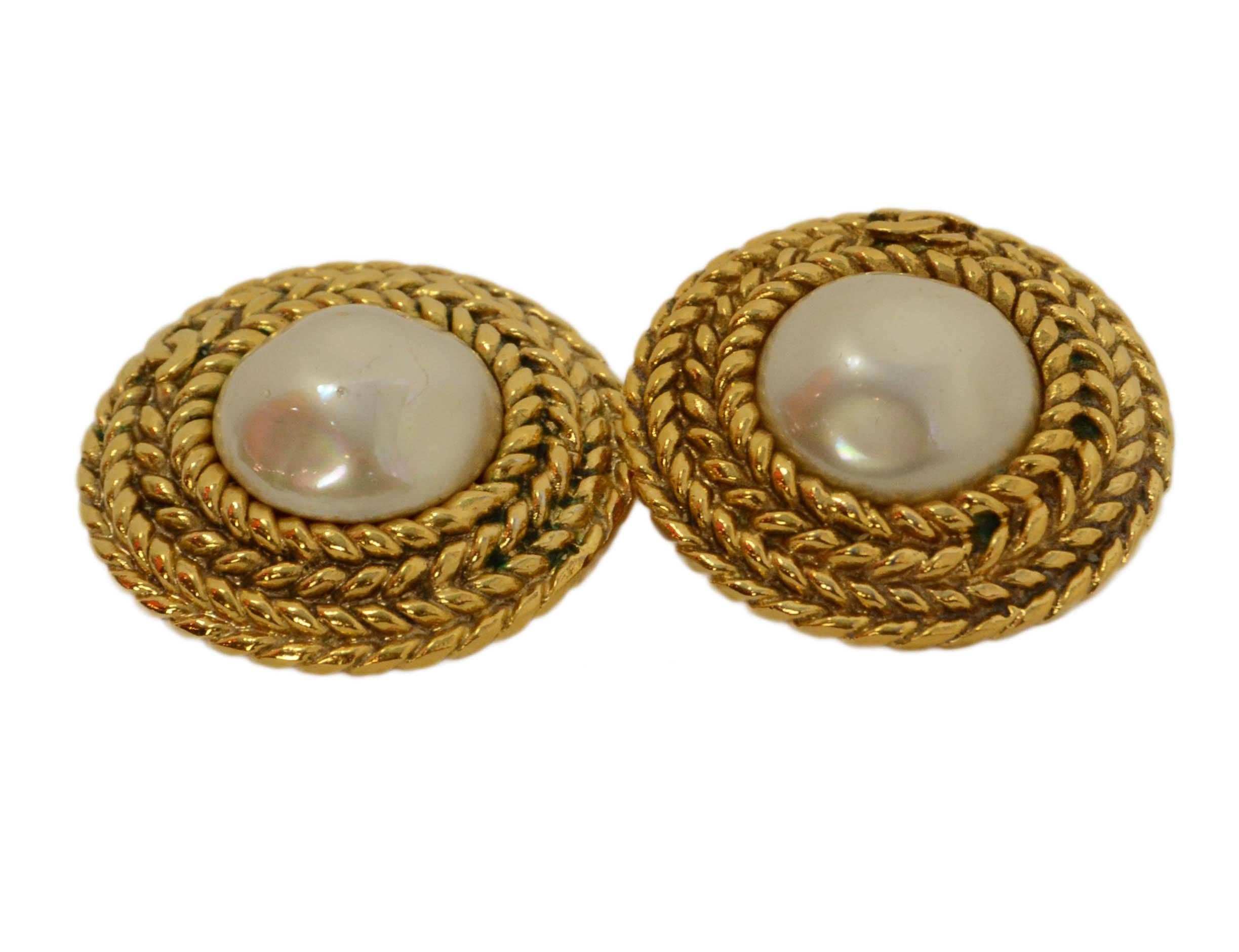 Chanel Faux Pearl Clip On Earrings With Braided Border

Made In: France

Year of Production: 1990-1992

Color: Gold, Faux Pearl

Materials: Faux pearl, metal

Closure/Opening: Clip on

Stamp: CHANEL CC MADE IN FRANCE

Overall
