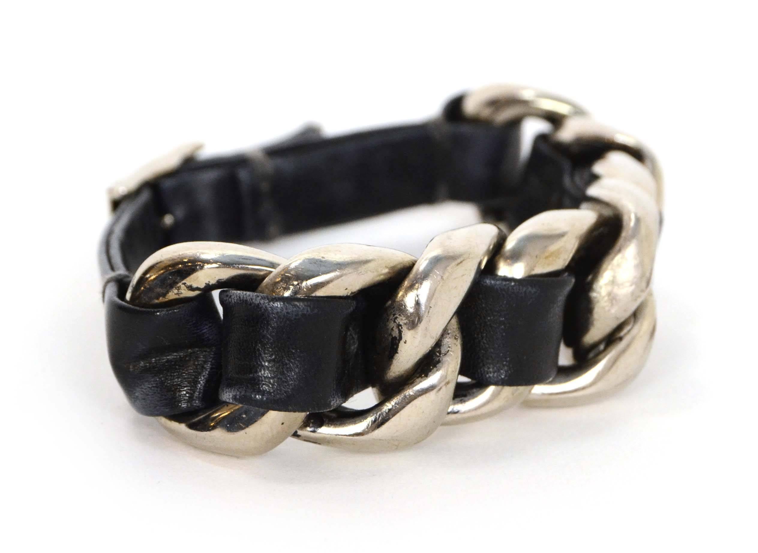 Chanel Leather Woven Chain Link Bracelet 
Features small silvertone CC pendant at closure
Made In: Italy
Year of Production: 2002
Color: Black and silvertone
Materials: Leather and metal
Closure: Buckle and notch closure
Stamp: 02 CC