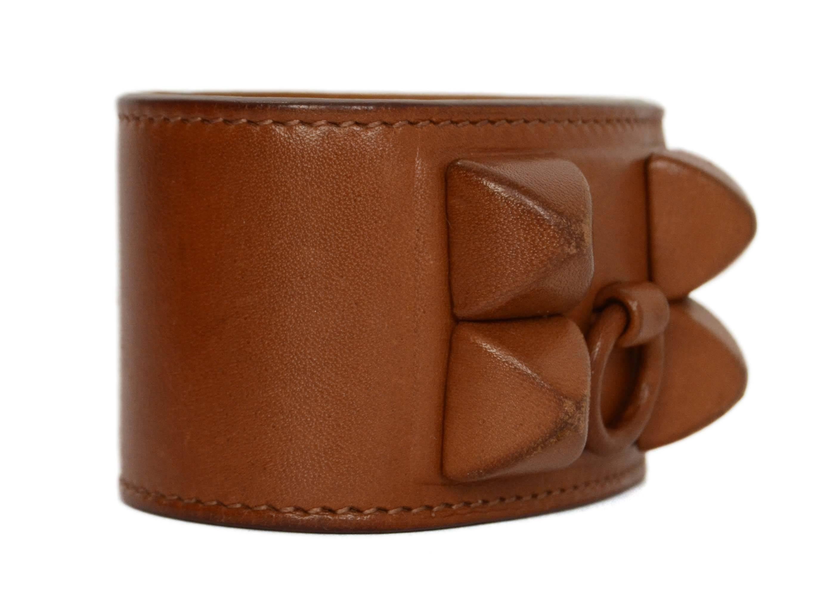 Hermes Brown Leather 'Shadow' CDC Cuff 
Features brown leather wrapped hardware
Made In: France
Year of Production: 2009
Color: Brown
Materials: Leather
Closure: Double snap closure
Stamp: M stamp in square
Overall Condition: Very good