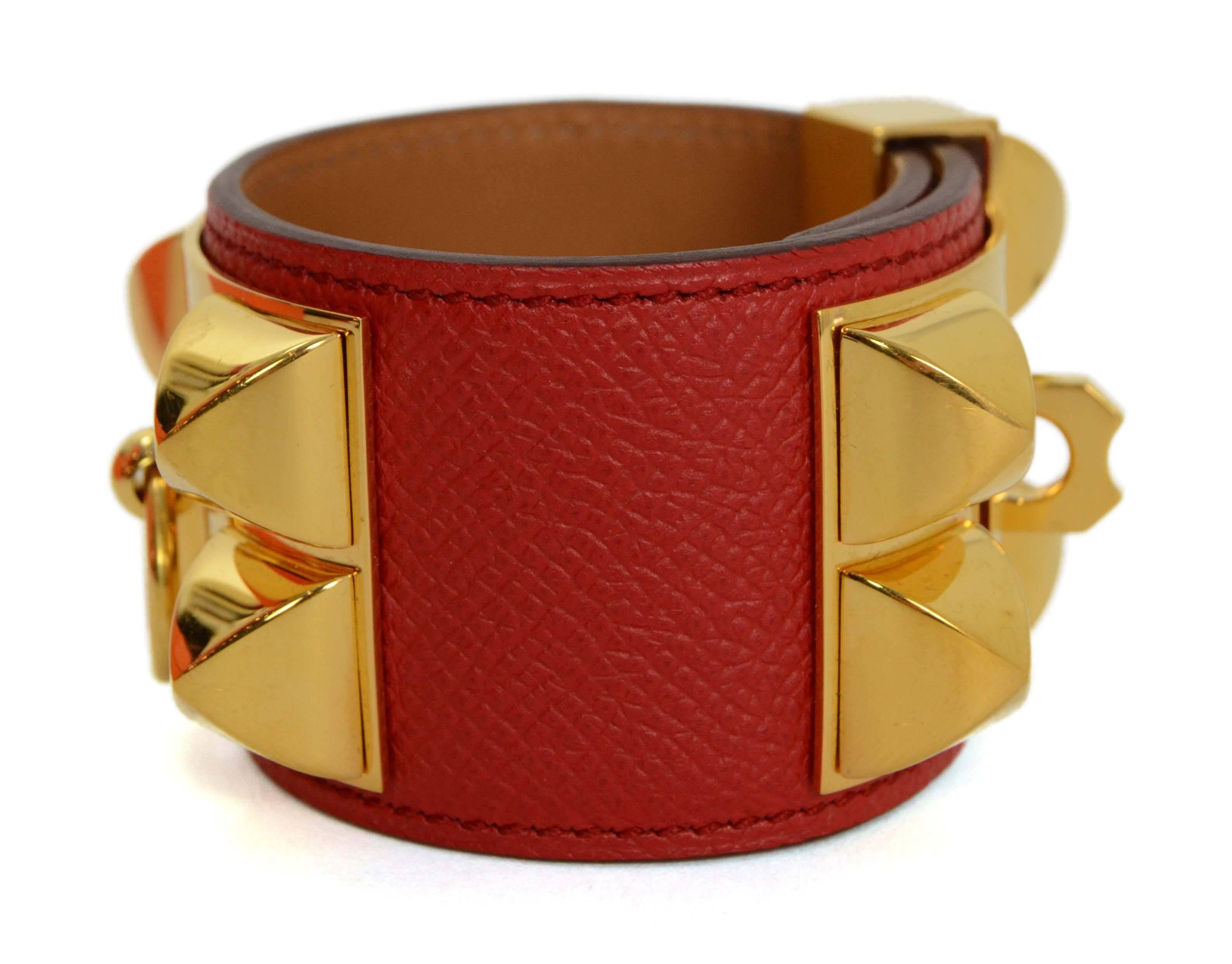 Hermes Rouge Casque Epsom CDC Cuff 
Made In: France
Year of Production: 2013
Color: Rouge casque red
Hardware: Goldtone
Materials: Epsom leather and metal
Closure: Stud and notch closure
Stamp: Q stamp in square
Overall Condition: Excellent