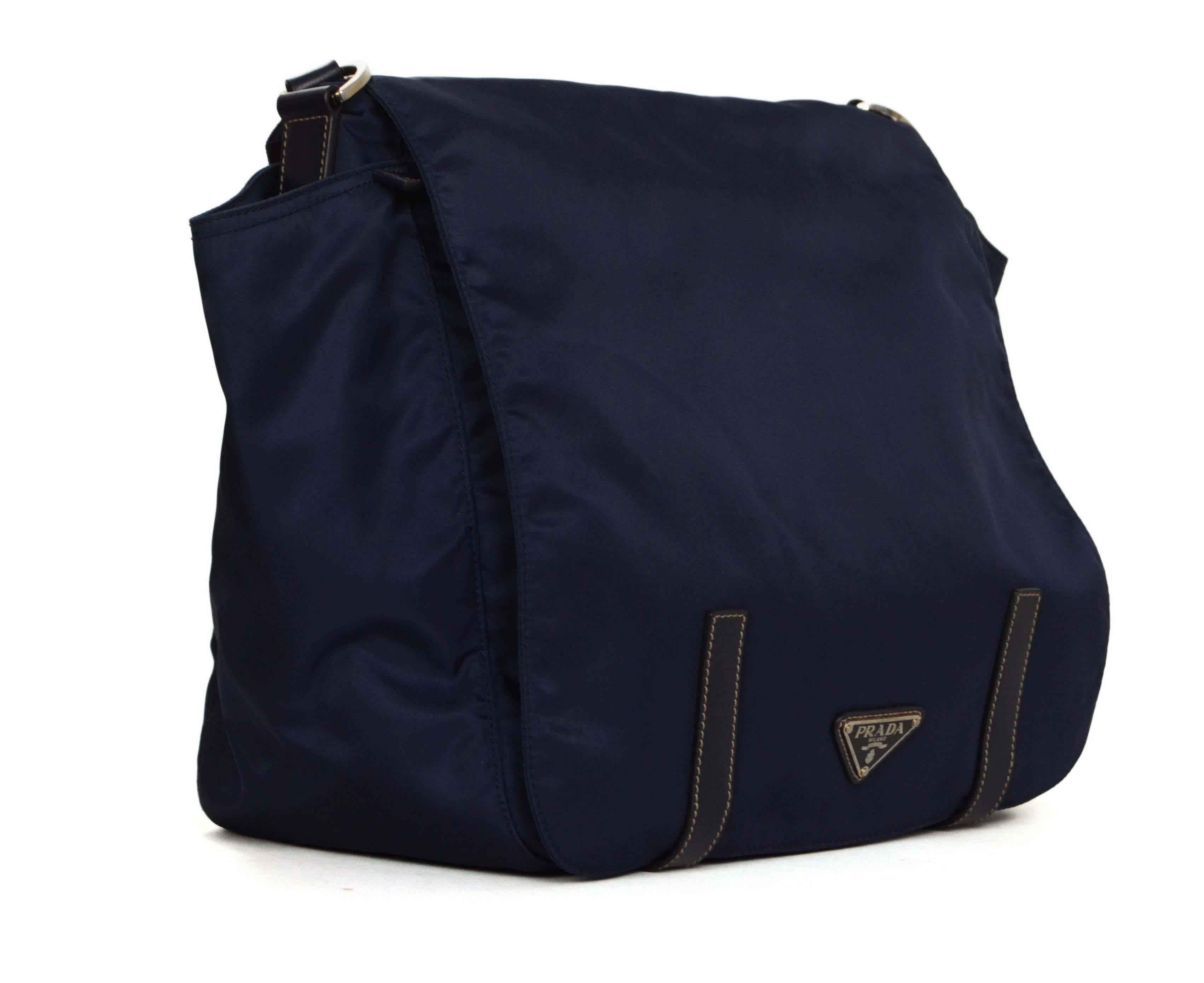 Features flap closure with two side pockets and adjustable strap
-Made In: Italy
-Color: Navy blue
-Hardware: Silvertone
-Materials: Nylon with leather strap closure
-Lining: Black monogram textile
-Closure/Opening: Zip top covered by flap