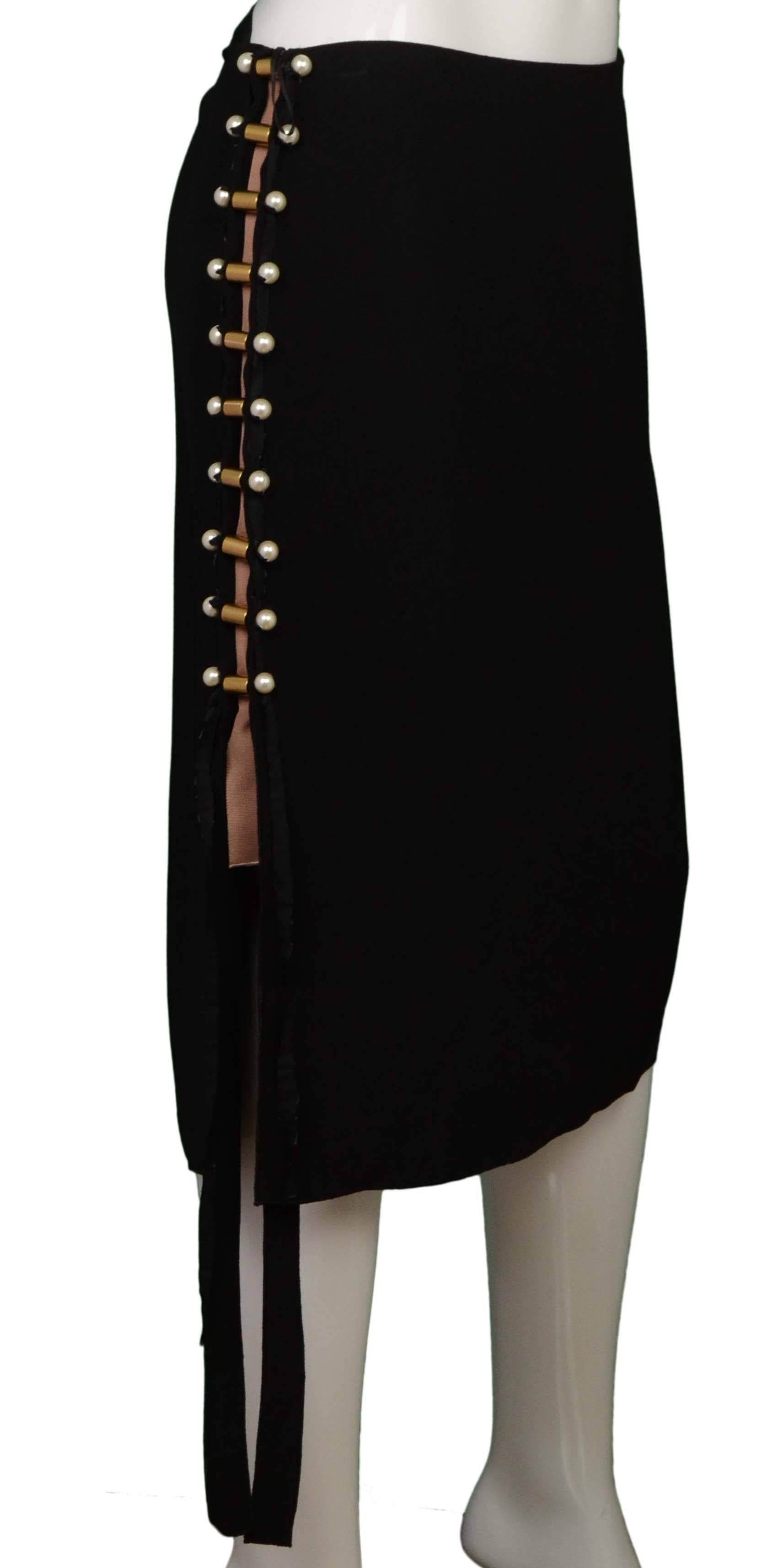 Lanvin Black Crepe Skirt 
Features pearl, ribbon and metal side detailing
Made In: France
Color: Black, ivory and tan
Composition: 52% acetate, 48% viscose
Lining: None
Closure/Opening: Side zipper
Exterior Pockets: None
Interior Pockets: