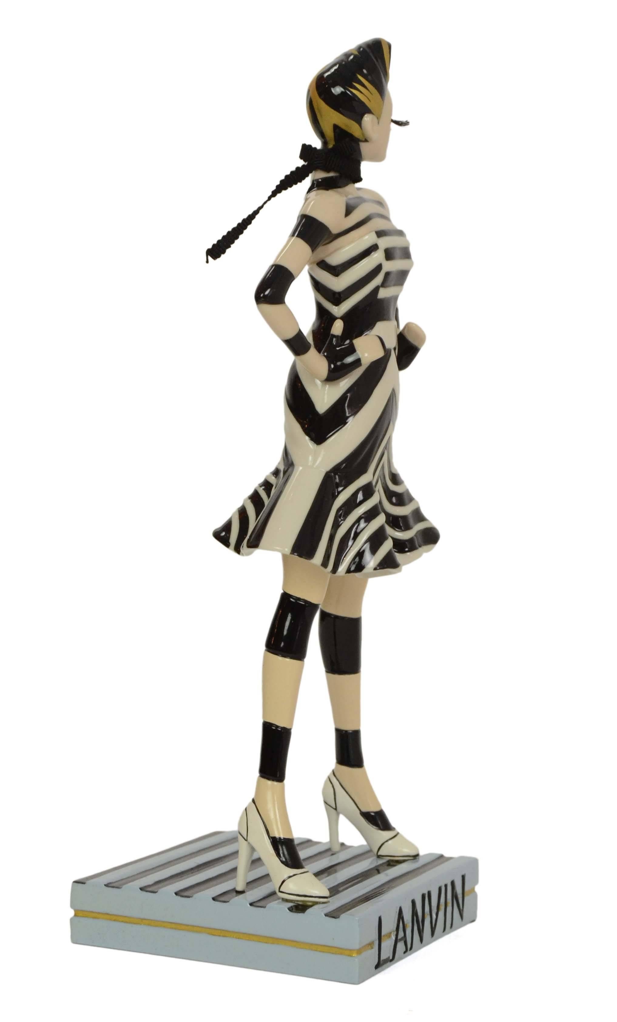 Lanvin Ltd Ed Miss Lanvin 46 Porcelain Figurine 
Features ribbon scarf and xl eye lashes
Made In: China
Color: Black, white, pale blue and bronze
Materials: Porcelain and ribbon
Stamp: No. 037/800
Retail Price: $685 + tax
Overall Condition: