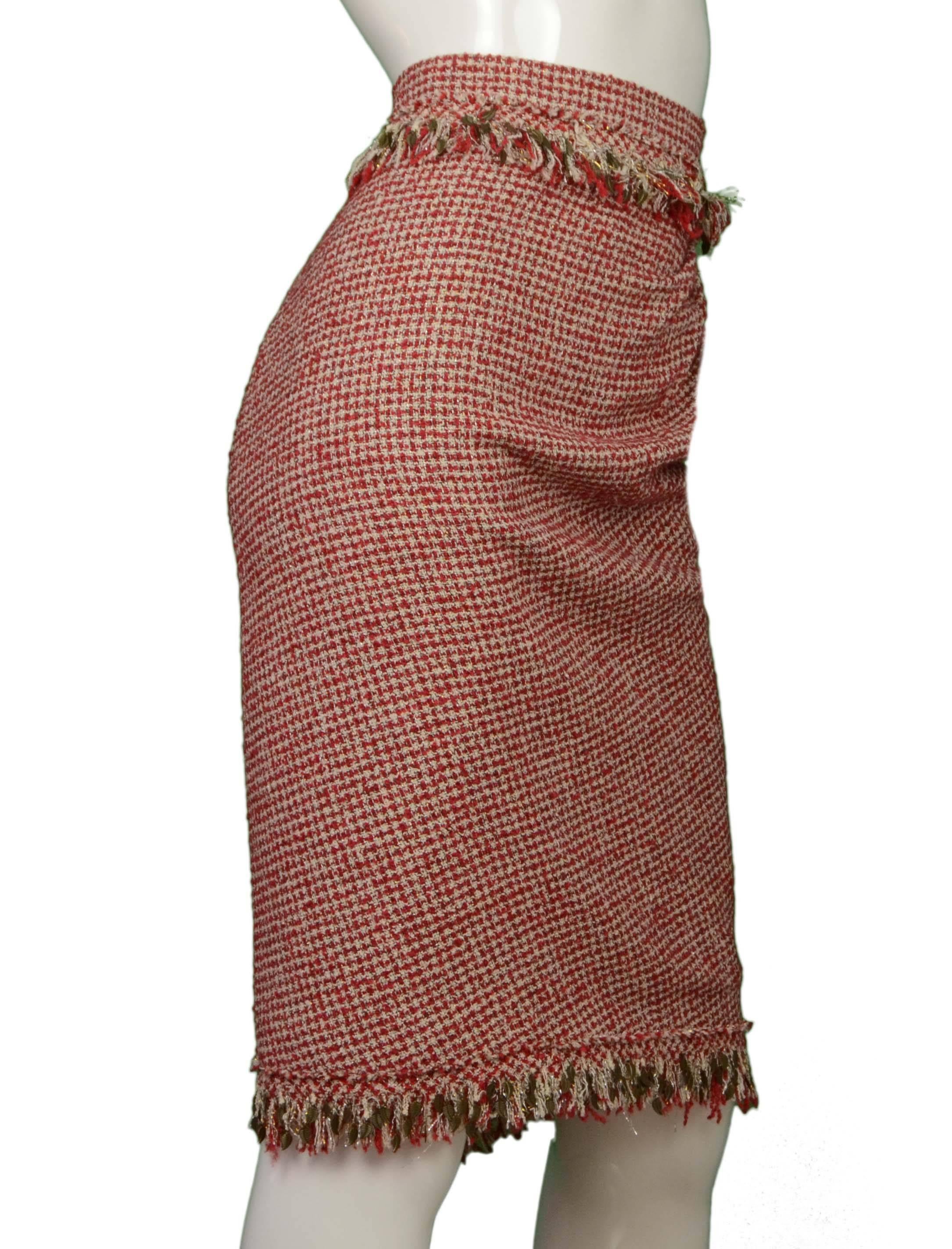 Chanel Red & White Tweed Skirt 
Features bronze metal leaf details throughout trim
Made In: France
Color: Red and white
Composition: 49% wool, 28% rayon, 10% nylon, 8% silk, 3% polyester, 2% metal
Lining: Taupe, 100% silk
Closure/Opening: Back