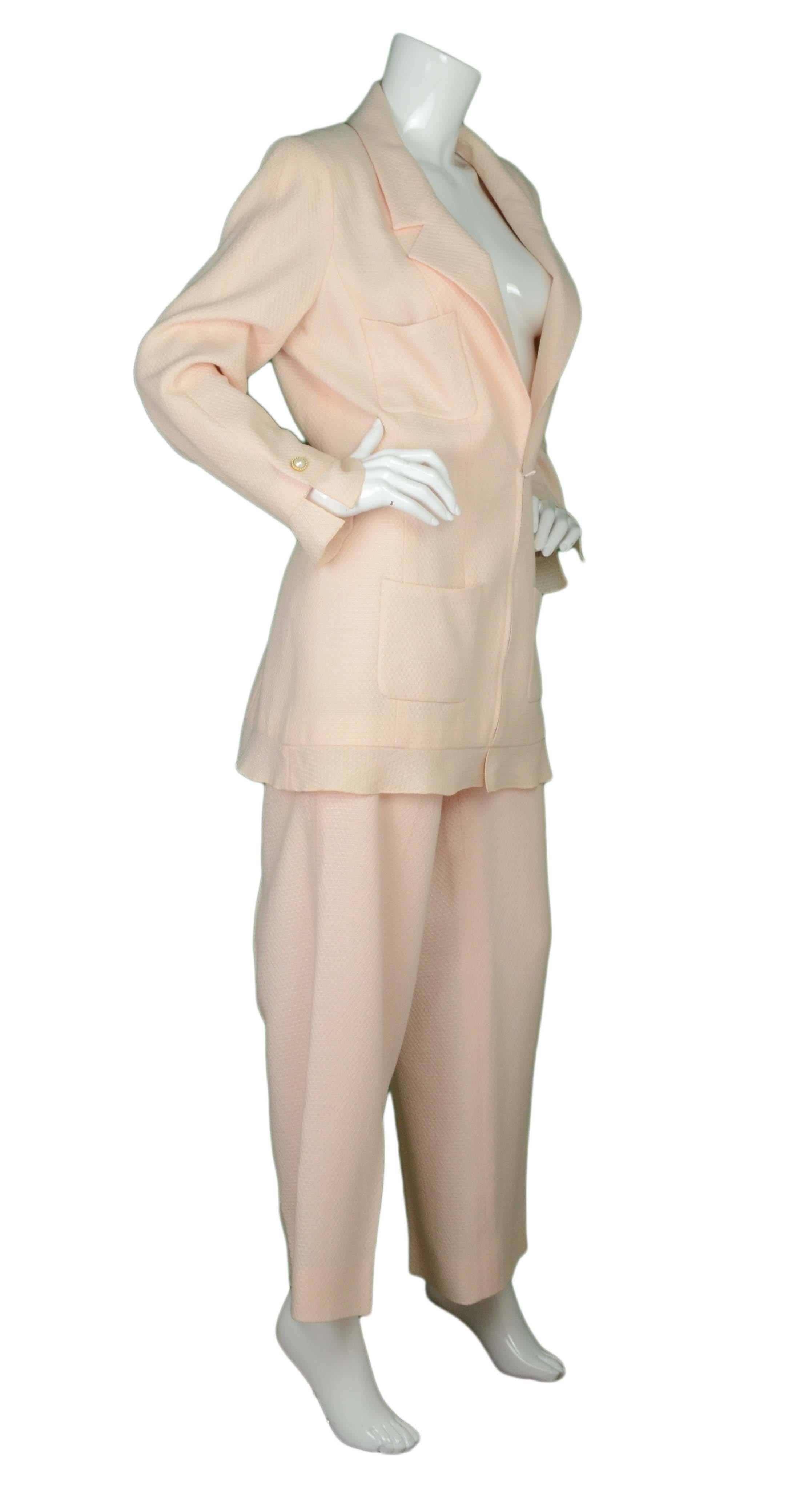 Chanel Pale Pink Wool Pant Suit 
Features faux pearl button details
Made In: France
Year of Production: 2002
Color: Pale pink/peach
Composition: 52% rayon, 48% wool
Lining: Jacket- pale pink, 95% silk, 5% spandex, Pants- pale pink, 90% silk,