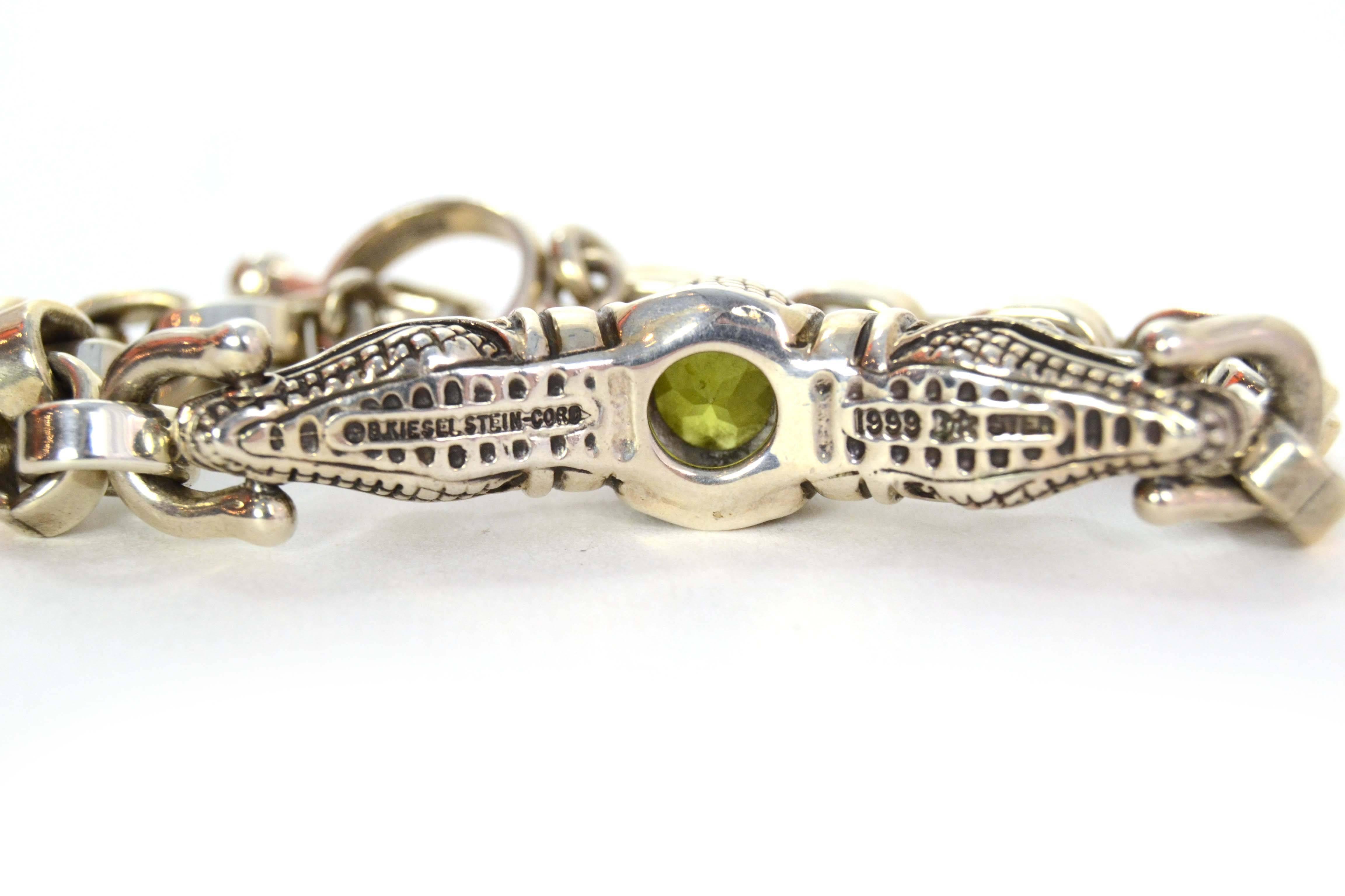 Barry Kieselstein-Cord Sterling Chain Link Gator Head Bracelet With Peridot Stone

    Made In: U.S.A

    Year of Production: 1999

    Color: Silver, green

    Materials: Sterling silver, Peridot

    Closure/Opening: Toggle closure

