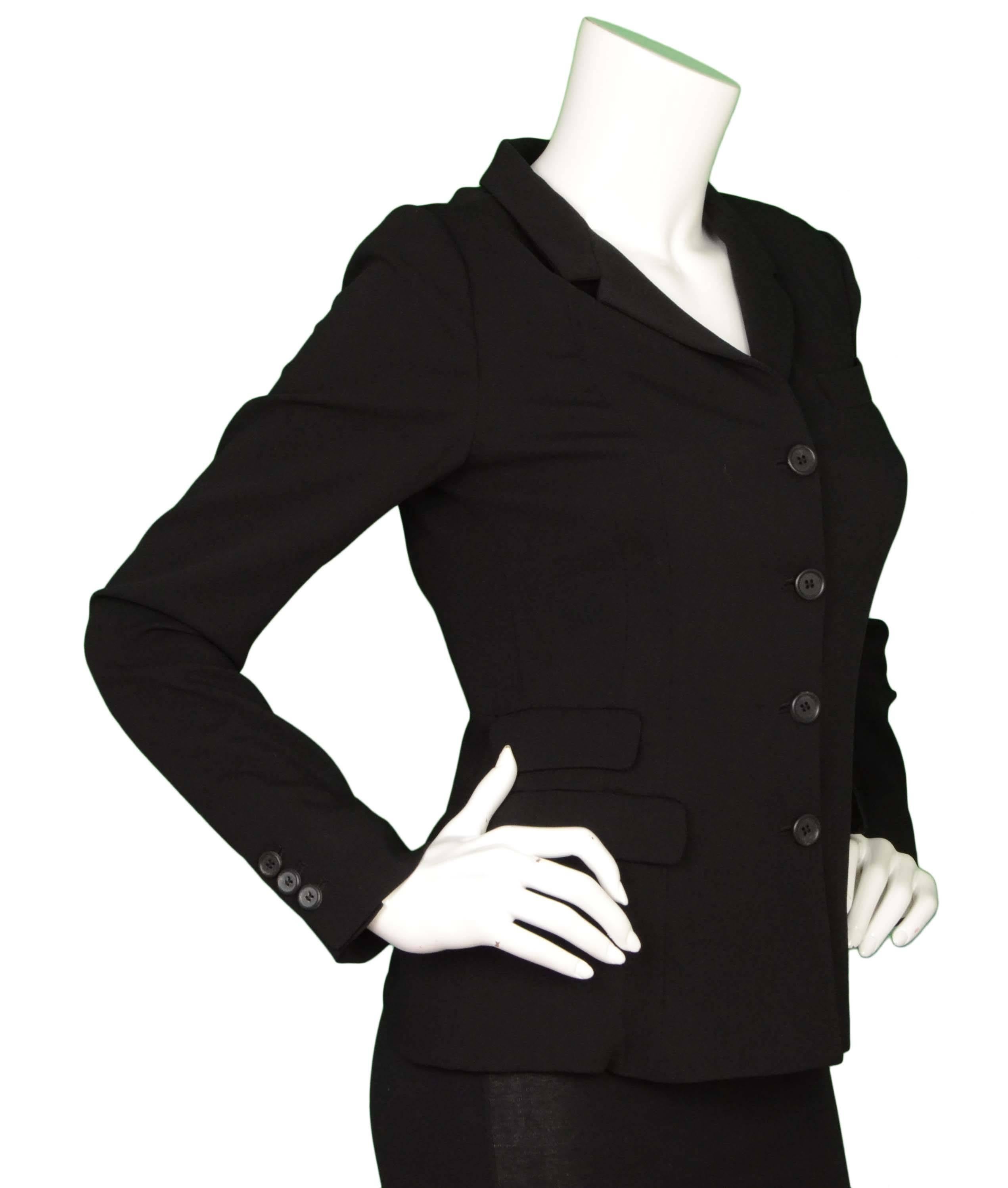 Prada Black Wool Blazer 
Features gathering in back to create bow-like detail
Made In: Italy
Color: Black
Composition: 71% wool, 29% silk
Lining: None
Closure/Opening: Front button down closure
Exterior Pockets: Three flap pockets and one