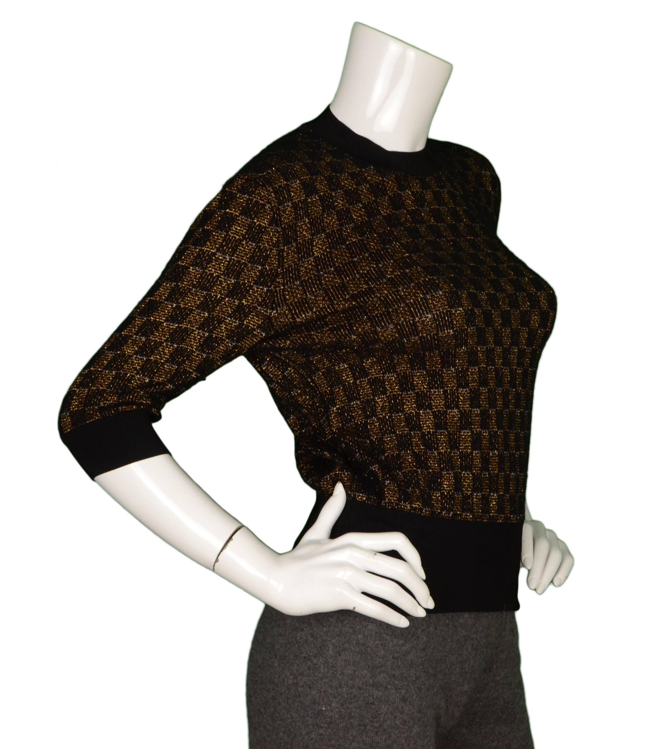 Louis Vuitton Black & Gold Knit Short Sleeve Top 
Made In: Italy
Color: Black and gold
Composition: 42% cashmere, 38% viscose, 8% polyamide, 6% cupro, 4% polyester, 2% elastane
Lining: None
Closure/Opening: Pull over top
Exterior Pockets: