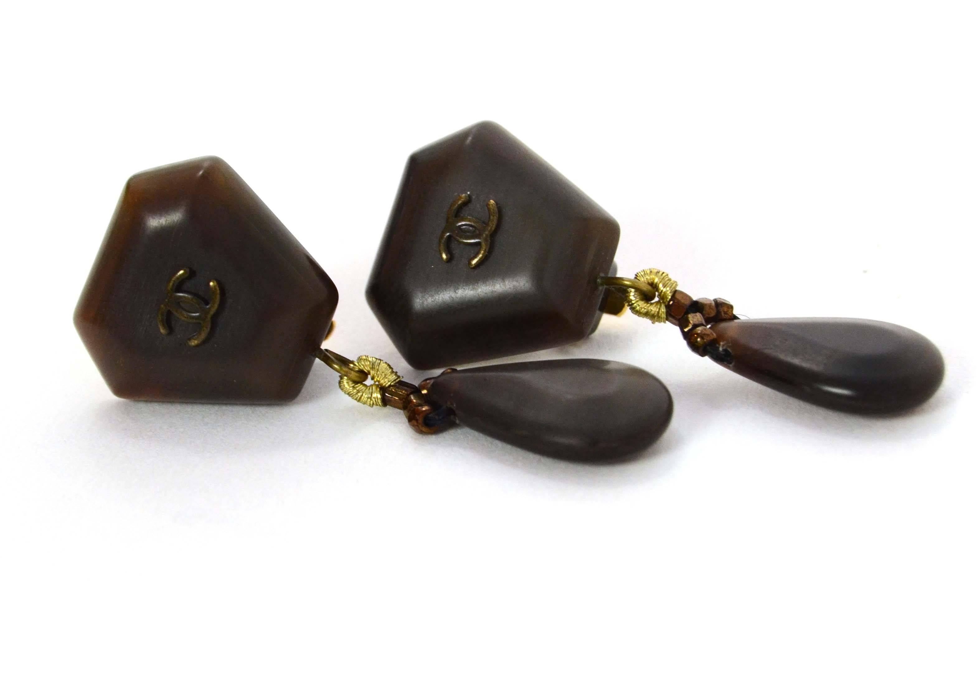 Chanel Vintage '99 Bronze Dangling Clip On Earrings 
Features small CC's at top portion
Made In: France
Year of Production: 1999
Color: Dark brown/bronze
Materials: Metal and stone
Closure: Clip on
Stamp: 99 CC A
Overall Condition: Excellent