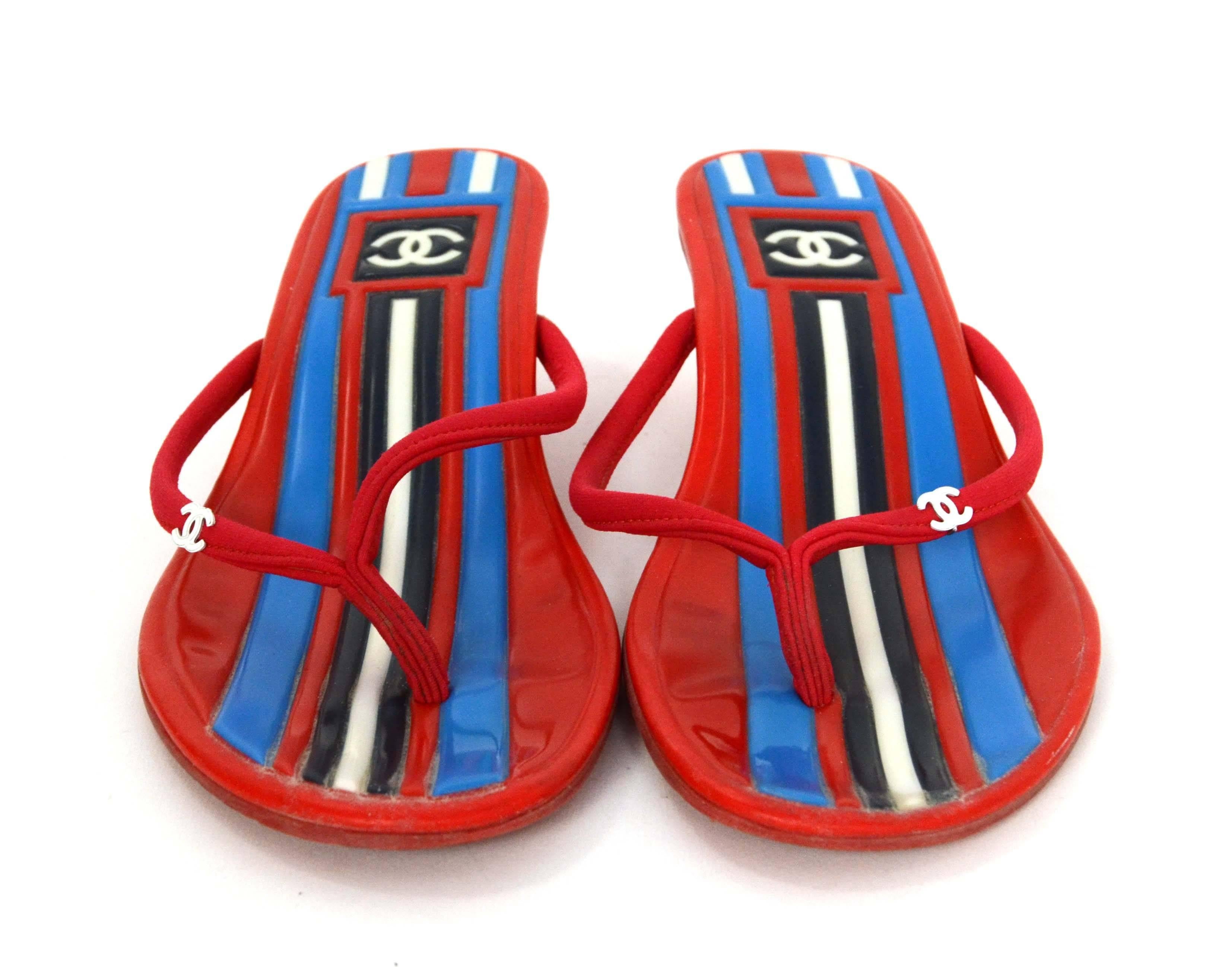Chanel Red & White Rubber Kitten Heel Thong Sandals 
Features light blue and navy stripes through insole
Made In: Italy
Color: Red, white, blue and navy
Materials: Rubber
Sole Stamp: CC Made in Italy 36 1/2
Overall Condition: Excellent with