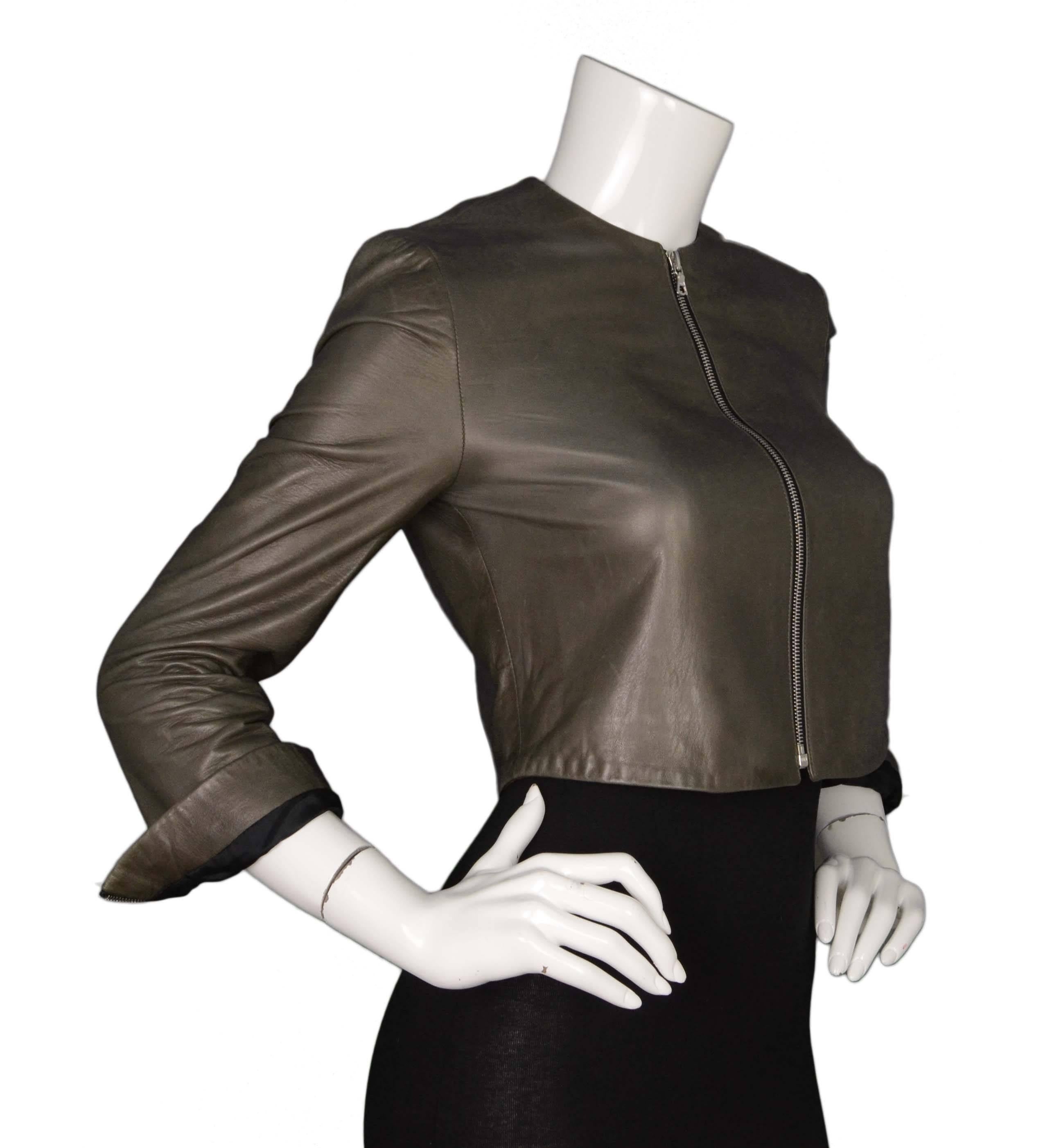 The Row Grey Leather Cropped Jacket 
Made In: U.S.A.
Color: Grey
Materials: 100% lambskin
Lining: Black, 100% cotton
Closure/Opening: Zip up closure
Exterior Pockets: None
Interior Pockets: None
Overall Condition: Excellent pre-owned