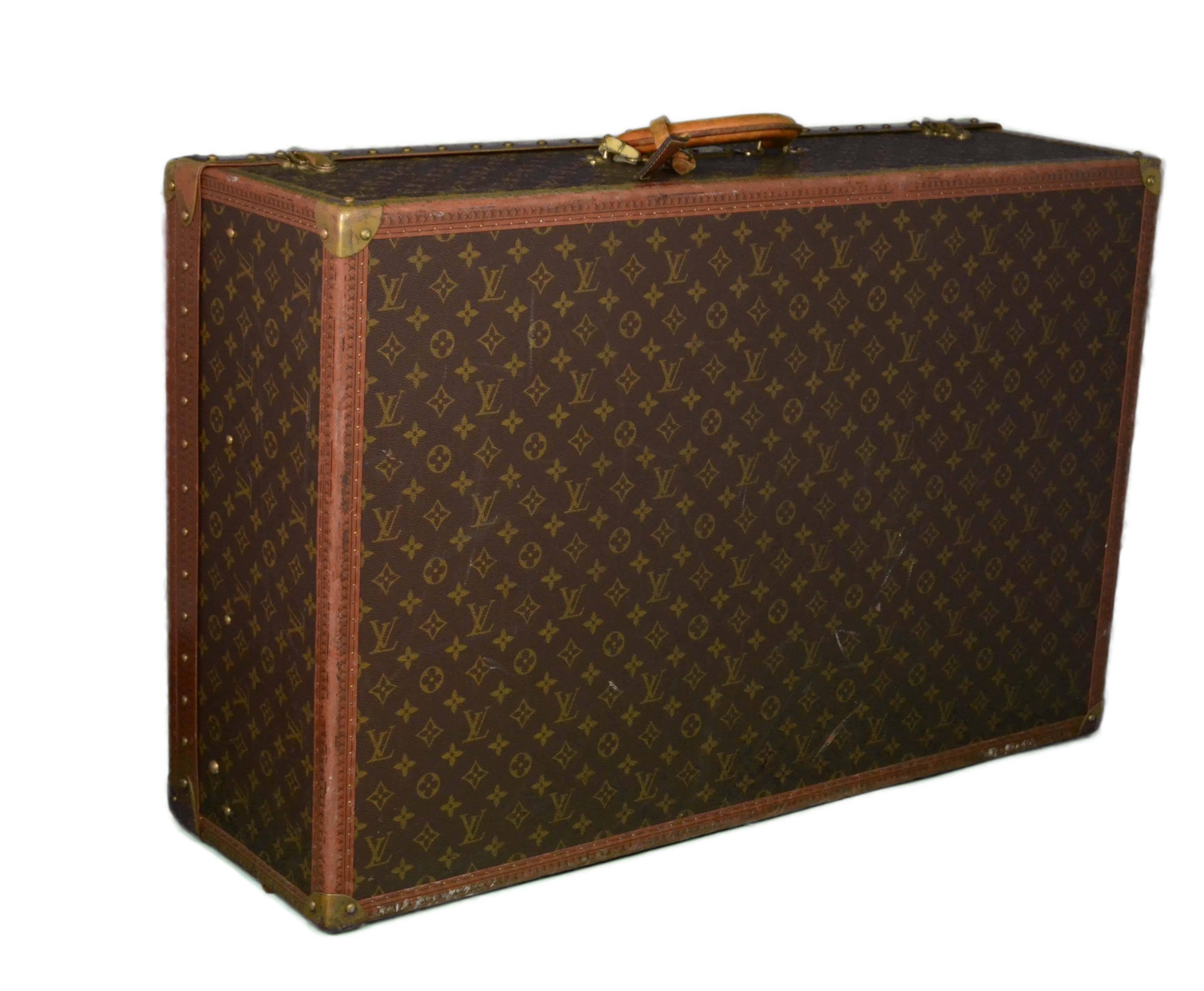 Louis Vuitton Vintage Monogram 80cm Hard Suitcase 
Features leather wrapped handle and brass hard corners

Made In: France
Color: Brown and tan
Hardware: Brass
Materials: Metal, leather, and coated canvas
Lining: Nude leather
Closure/Opening: Triple