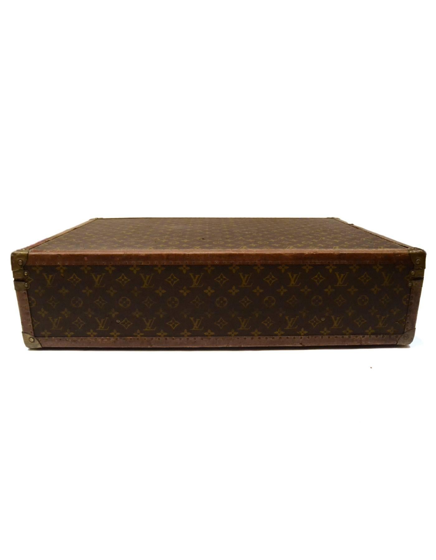 Louis Vuitton Vintage Monogram Hard Suitcase 

Made In: France
Color: Brown and tan
Hardware: Brass
Materials: Leather, metal and coated canvas
Lining: Beige canvas
Closure/Opening: Triple trunk latch closure
Exterior Pockets: None
Interior Pockets: