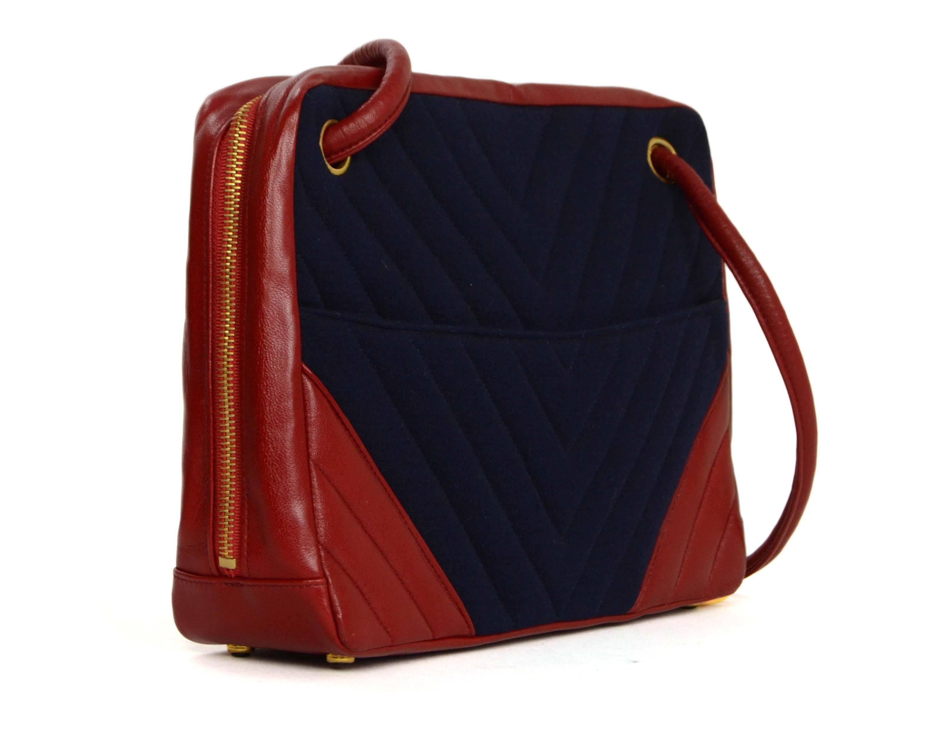 Chanel Vintage '90s Navy & Red Chevron Quilted Bag 
Features navy jersey and red leather and oversized goldtone CC zipper pull
Made In: France
Year of Production: 1989-1991
Color: Red and navy
Hardware: Goldtone
Materials: Jersey, leather and