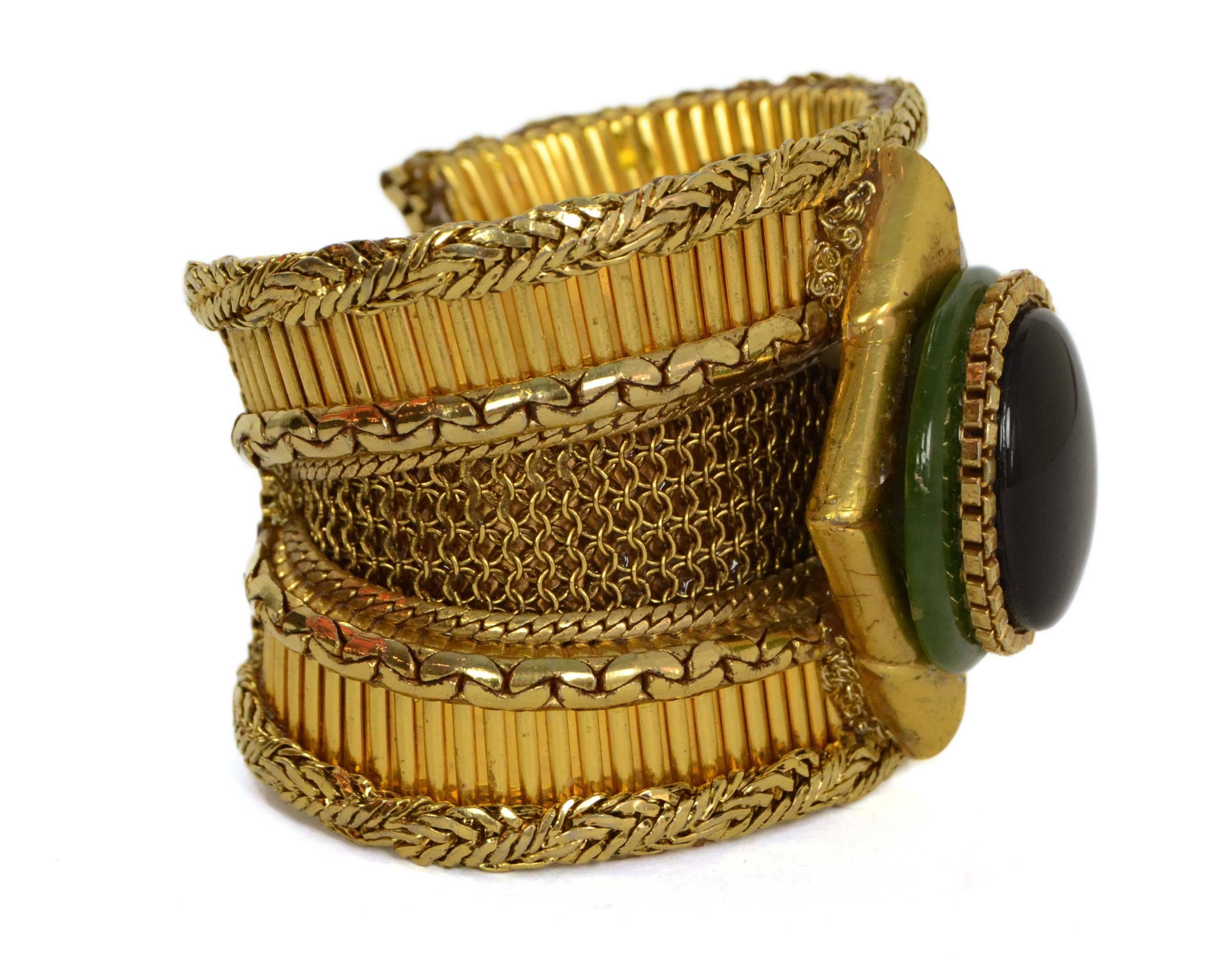 Wendy Gell Vintage '86 Textured Wide Gold Cuff 
Features black and green stones in center
Year of Production: 1986
Color: Goldtone, green and black
Materials: Metal and stone
Closure: None
Stamp: C Wendy Gell 1986
Overall Condition: Excellent