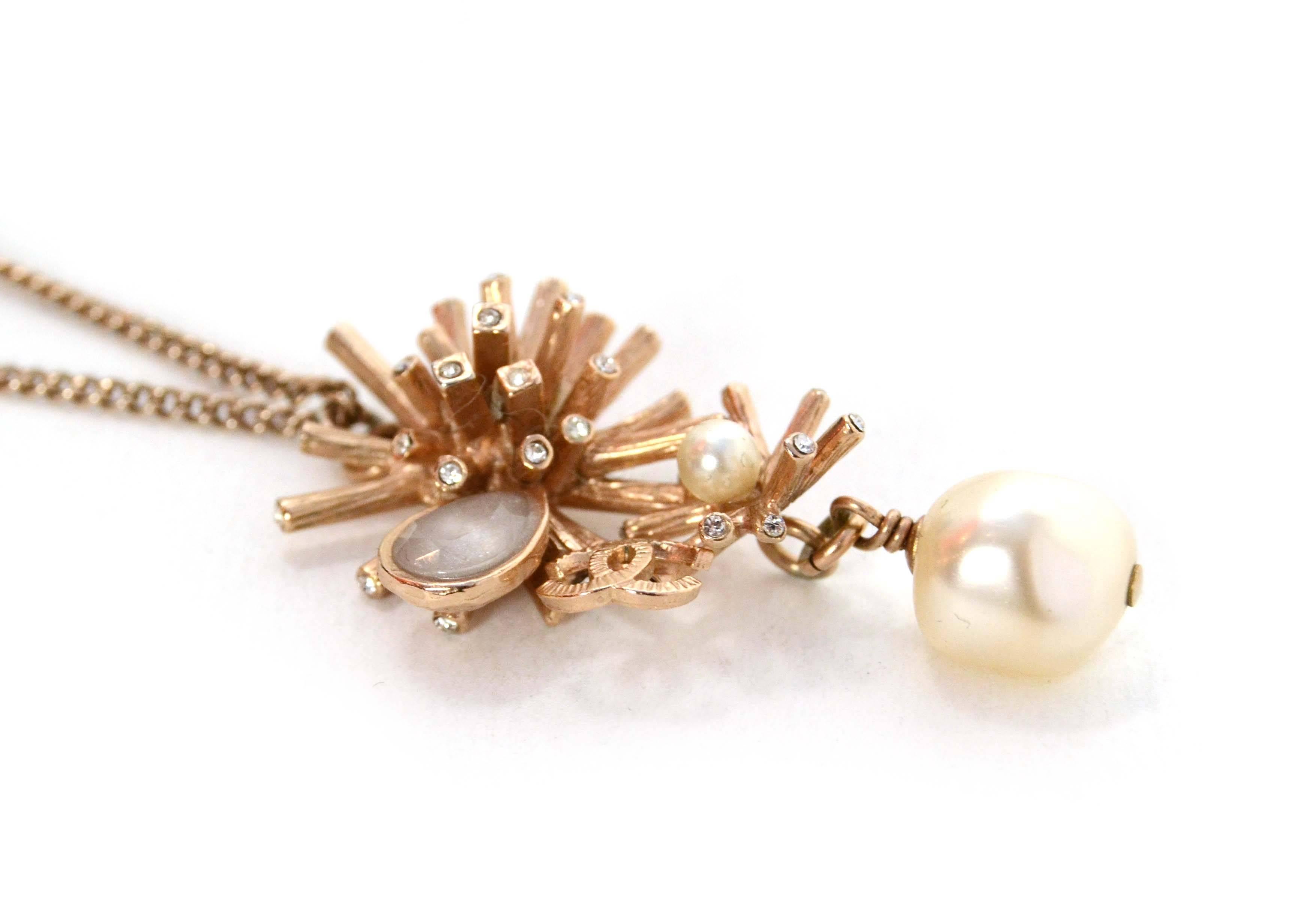 Chanel Gold Snowflake & Pearl Drop Necklace 
Features small tear rop stone and very small crystals at snowflake tips
Made In: Italy
Year of Production: 2012
Color: Goldtone and ivory
Materials: Metal, faux pearl, crystal and glass
Closure: