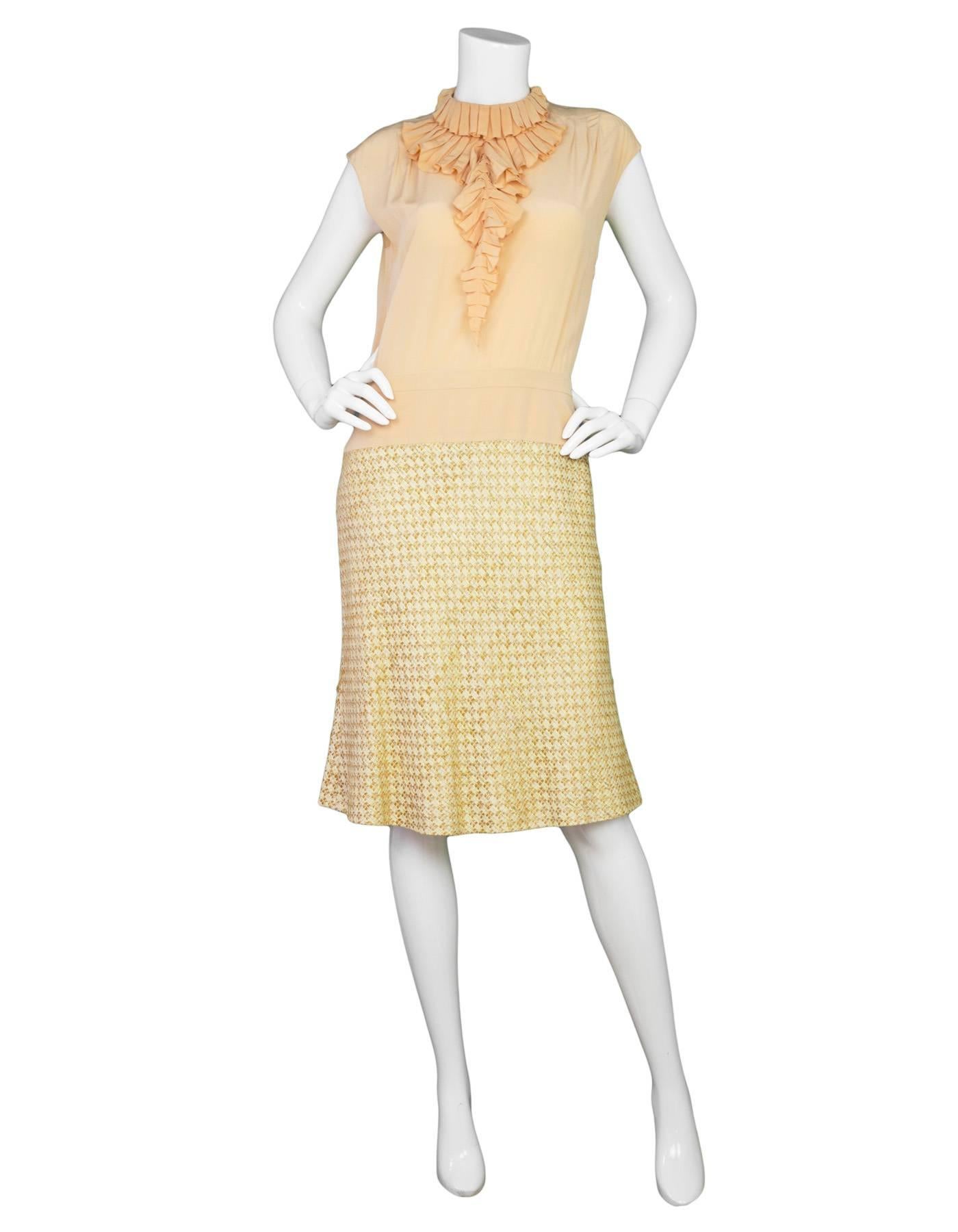 Chanel Peach Silk & Tweed Sleeveless Dress
Features removable ruffle neck tie

Made In: France
Year of Production: 2001
Color: Peach
Materials: 72% Rayon, 28% Cotton 
Lining: 100% Silk
Closure/Opening: Zipper at the side of the dress as well as
