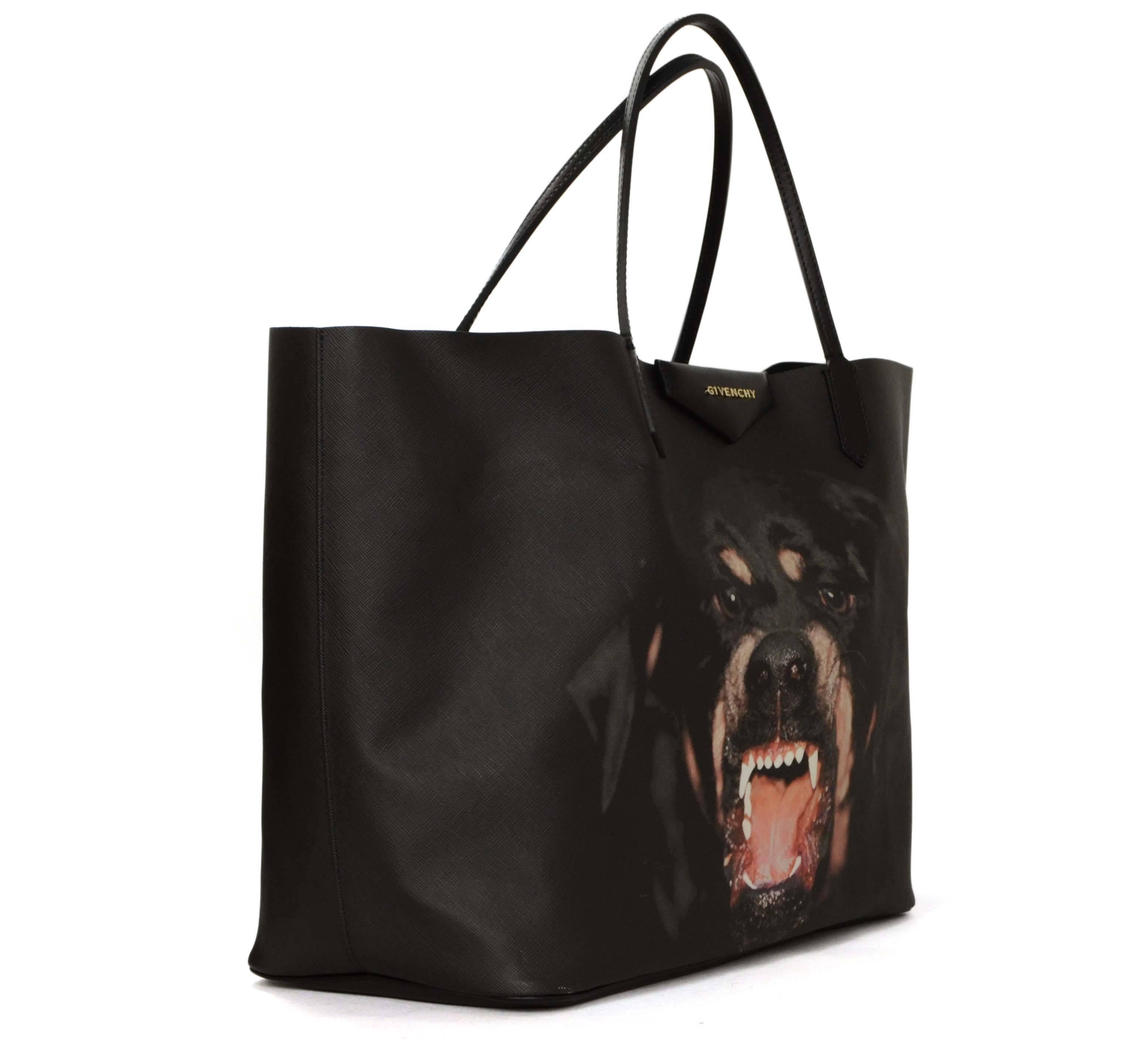 Features Givenchy's sold out rottweiler print

Made In: Hungary
Color: Black
Hardware: Goldtone
Materials: Black PVC with leather trim
Lining: Black cotton
Closure/Opening: Open
Exterior Pockets: None
Interior Pockets: None- comes with a