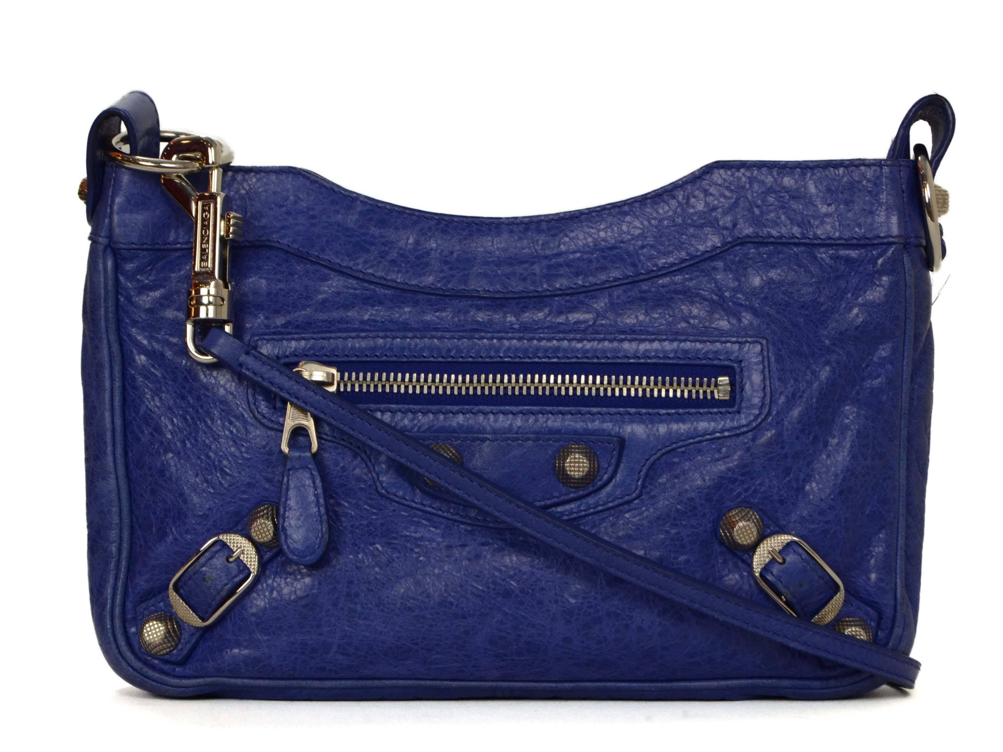 Features silvertone giant hardware and detachable crossbody strap

-Made In: Italy
-Color: Cobalt blue
-Hardware: Silvertone
-Materials: Agneau lambskin leather
-Lining: Black canvas-blend textile
-Closure/Opening: Zip top
-Exterior Pockets: