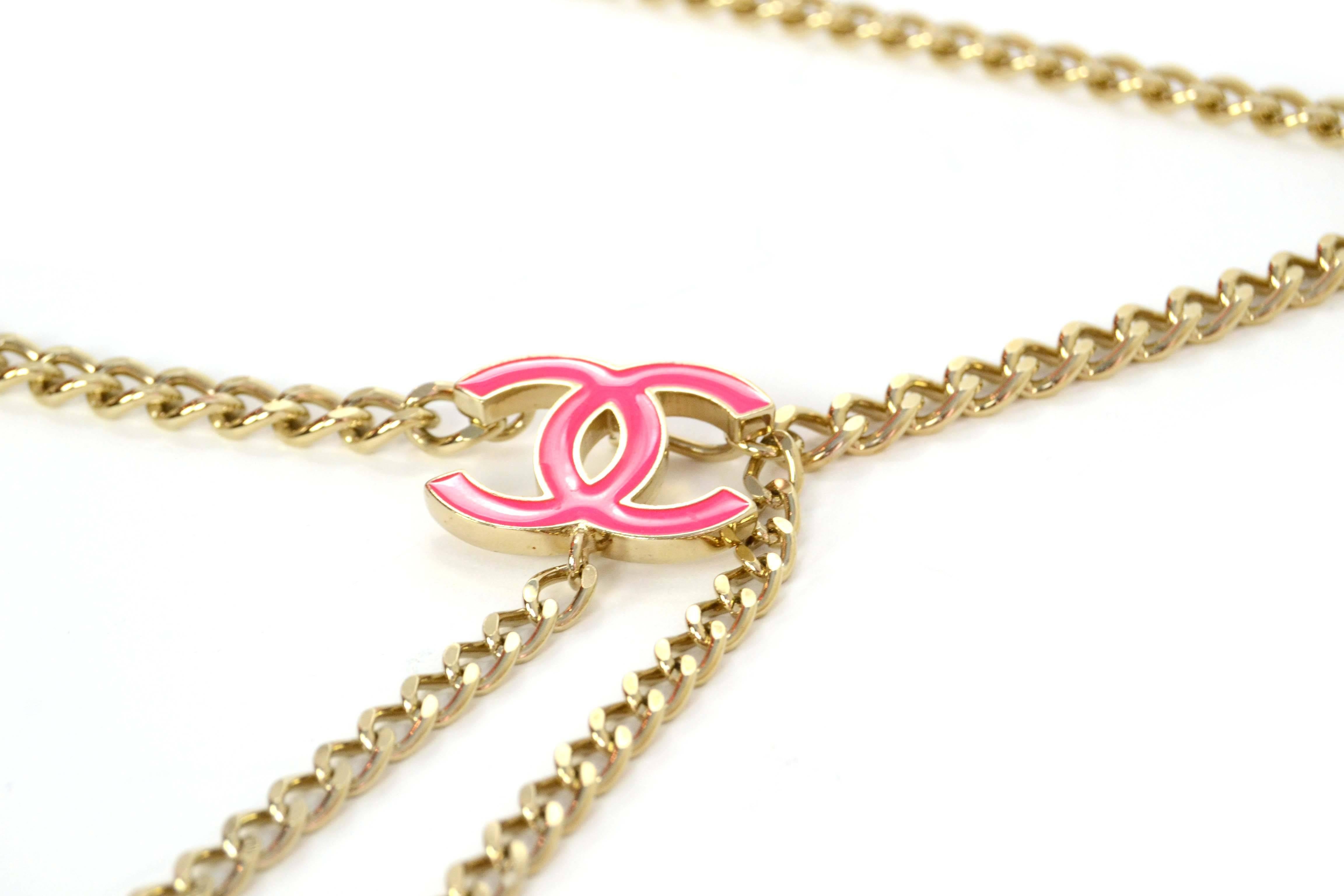 Features light goldtone chain with one large CC and two smal CCs at each end of belt. 

-Made In: Italy
-Year of Production: 2004
-Color: Light goldtone and neon pink
-Materials: Metal and enamel
-Closure: Hook can be placed anywear along