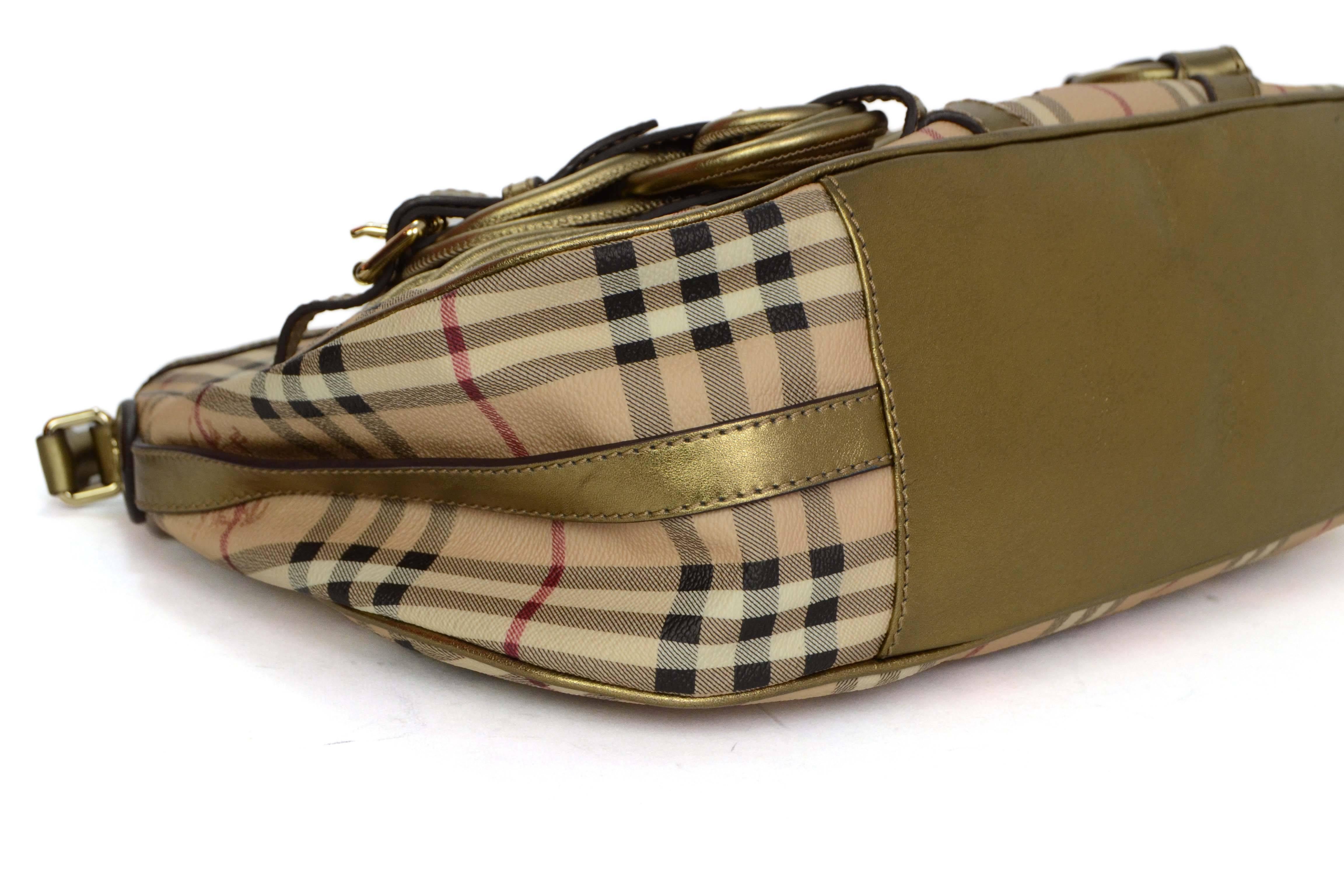 Features Buberry's classic nova plaid with bronze leather trim.  Woven leather by base of bag adds a unique flare to this classic style.

-Made In: Italy
-Color: Tan with black, burgundy and cream plaid
-Hardware: Goldtone
-Materials: Canvas