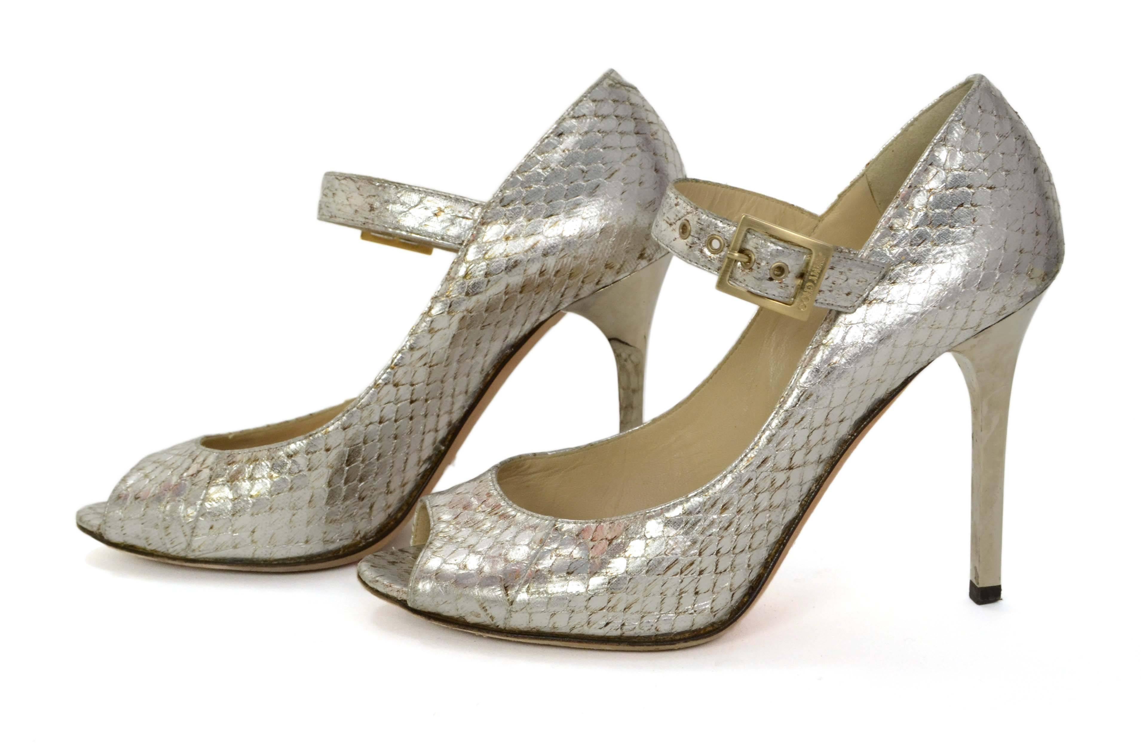 Jimmy Choo Silver Python Peep-Toe Mary Jane Pumps 
Features silver metal rectangular heel
Made In: Italy
Color: Silver
Materials: Python and metal
Closure: Ankle strap with buckle and notch closure
Sole Stamp: Jimmy Choo London Made in Italy