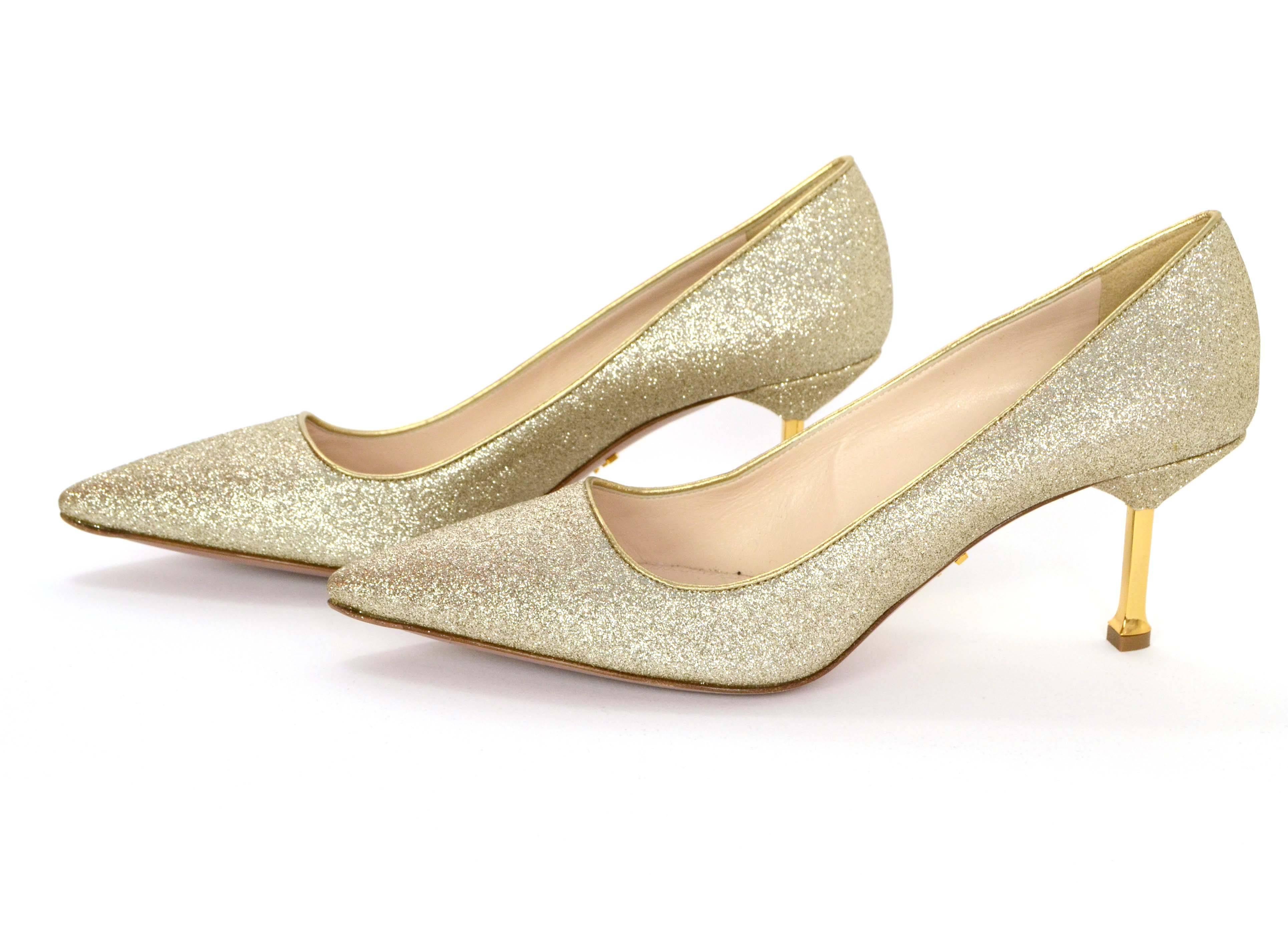 Prada Gold Glitter Kitten Heel Pumps 
Features gold metal covered heels
Made In: Italy
Color: Gold
Materials: Metal, leather and glitter
Closure: Slide on
Sole Stamp: Made in Italy 38 1/2 Prada Milano Dal 1913
Overall Condition: Excellent