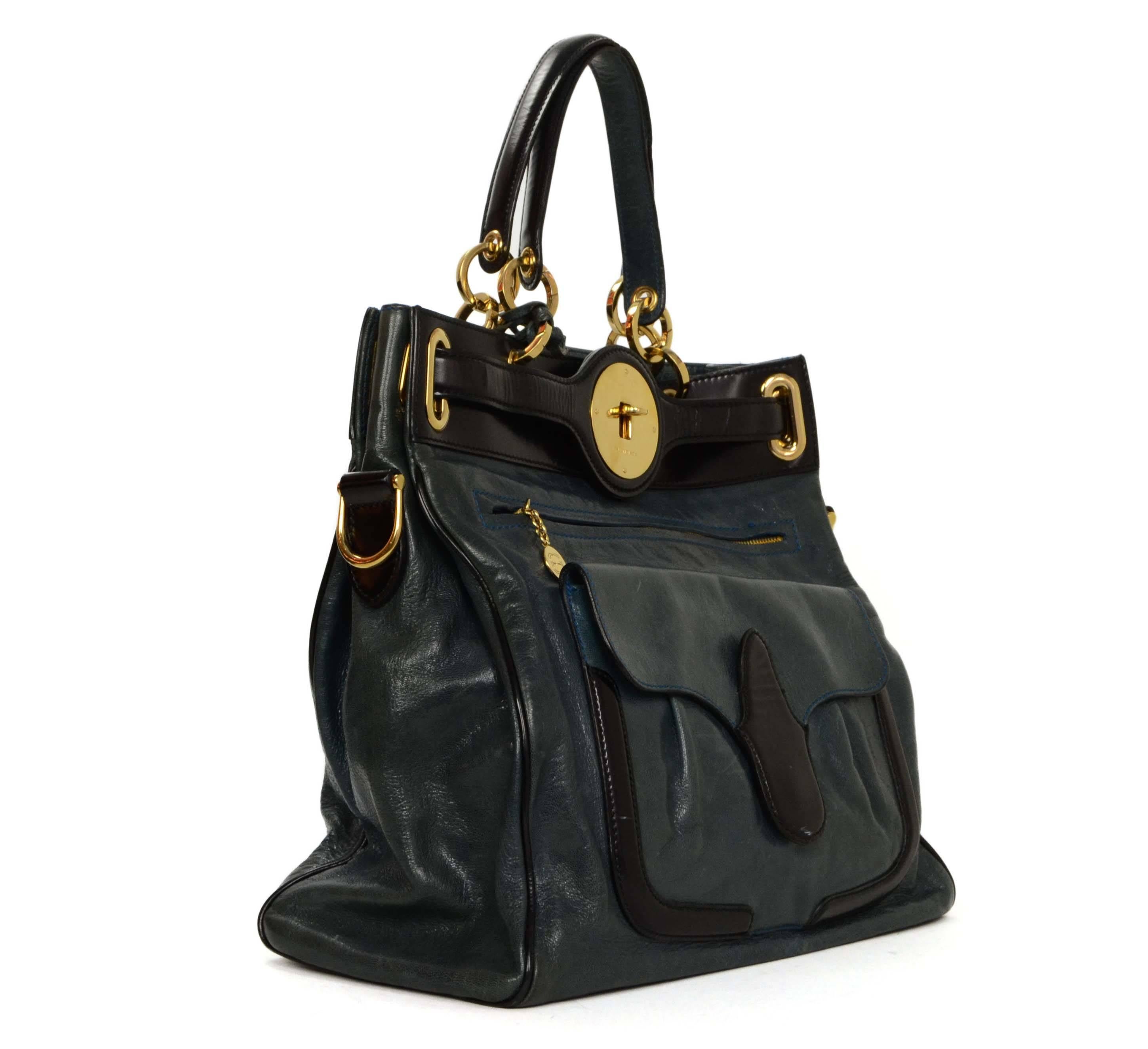 Balenciaga Blue & Black Leather 'Moon' Bag 
Features bright blue contrast stitching
Made In: Italy
Color: Black and blue
Hardware: Goldtone
Materials: Leather
Lining: Black canvas
Closure/Opening: Leather straps with twist lock
