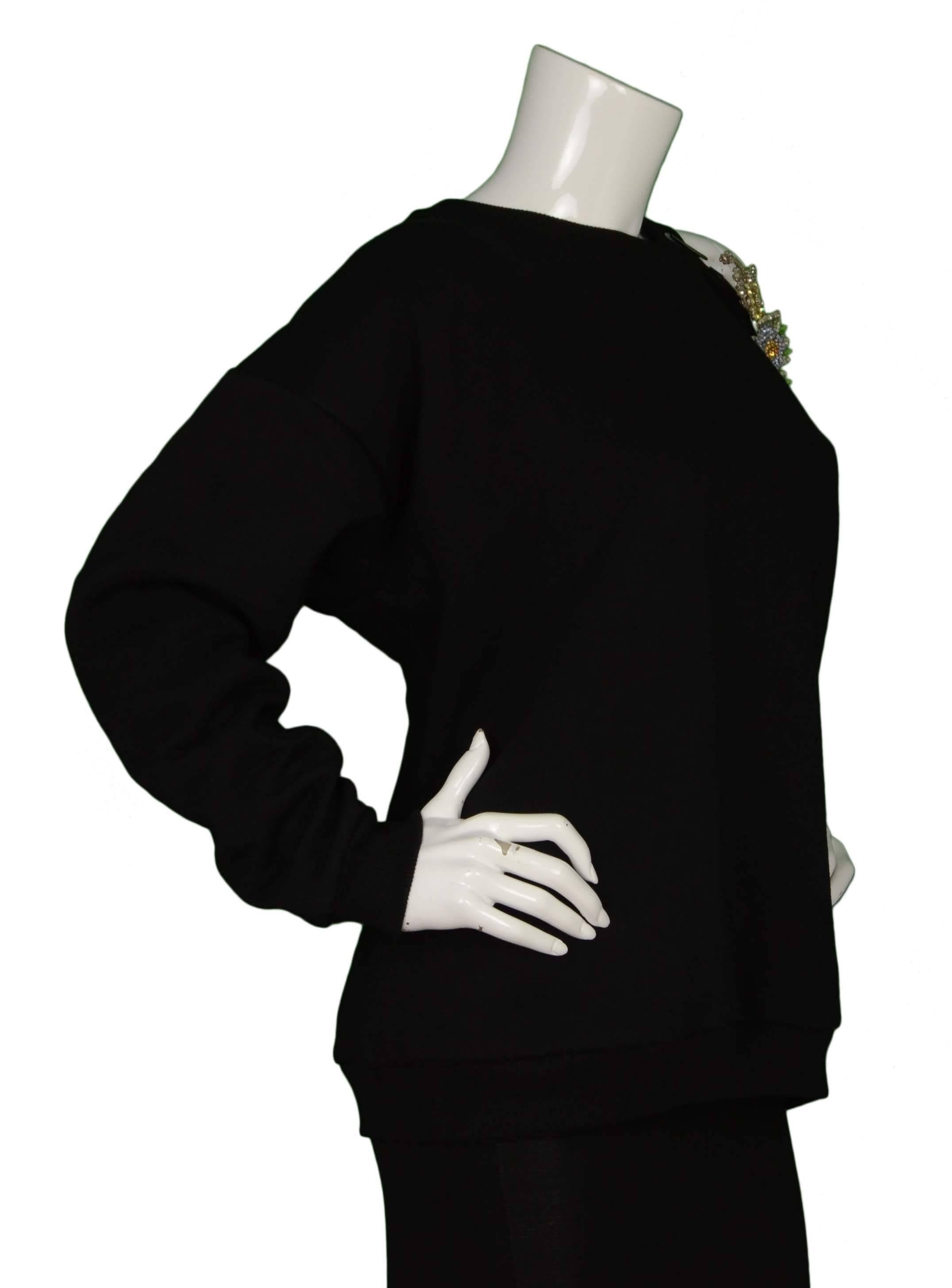 Christopher Kane Black Cotton & Rhinestone Cut Out Sweatshirt 
Features multi-colored rhinestone floral appliques at cut out shoulder
Made In: Italy
Color: Black and multi-color
Composition: 70% cotton, 30% polyester
Lining: 90% cotton, 10%