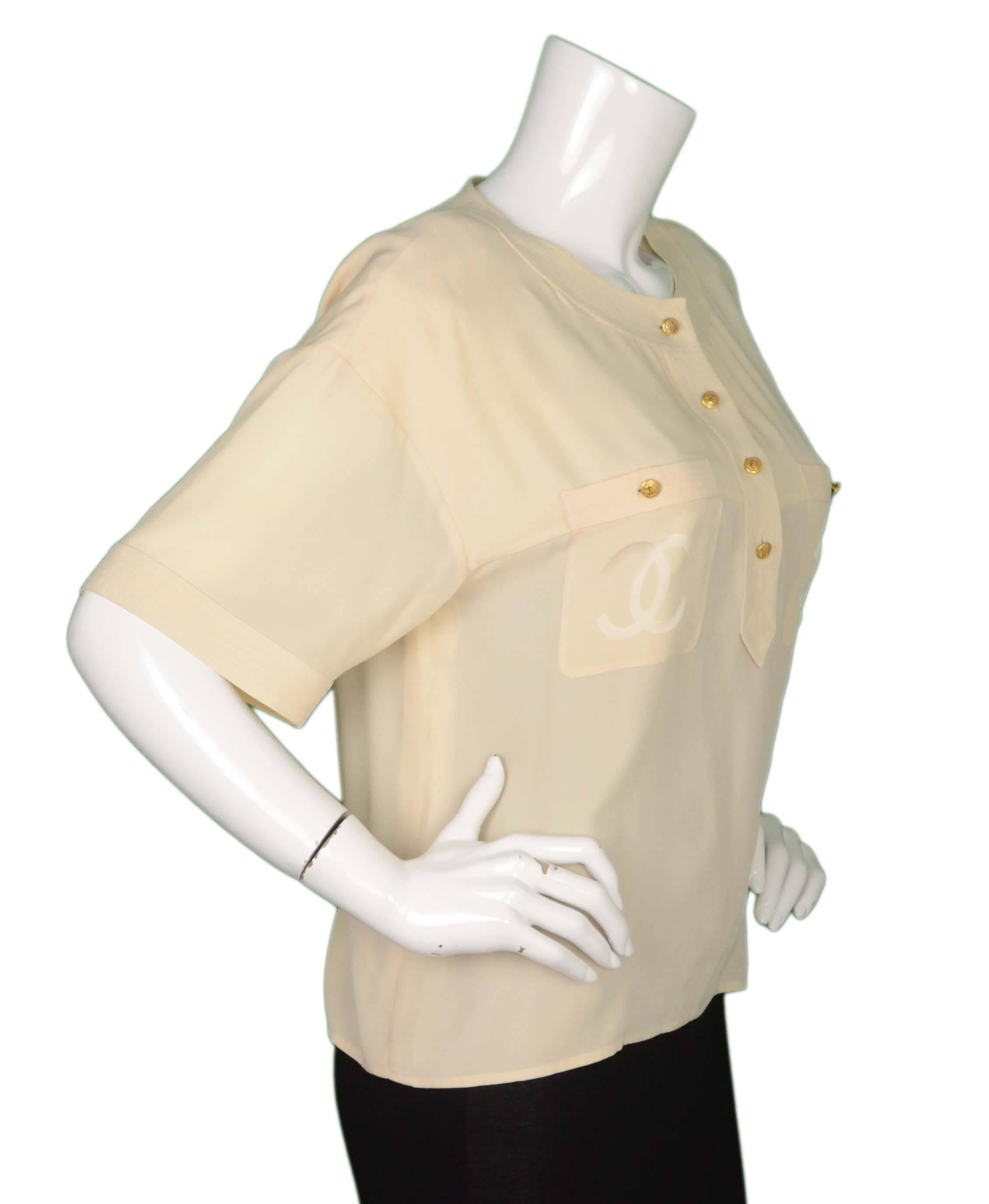 Chanel Vintage Cream Silk Button Down Blouse 
Features CC's printed on breast pockets
Made In: France
Color: Cream
Composition: Not given- believed to be 100% silk
Lining: None
Closure/Opening: Button down front
Exterior Pockets: Two patch