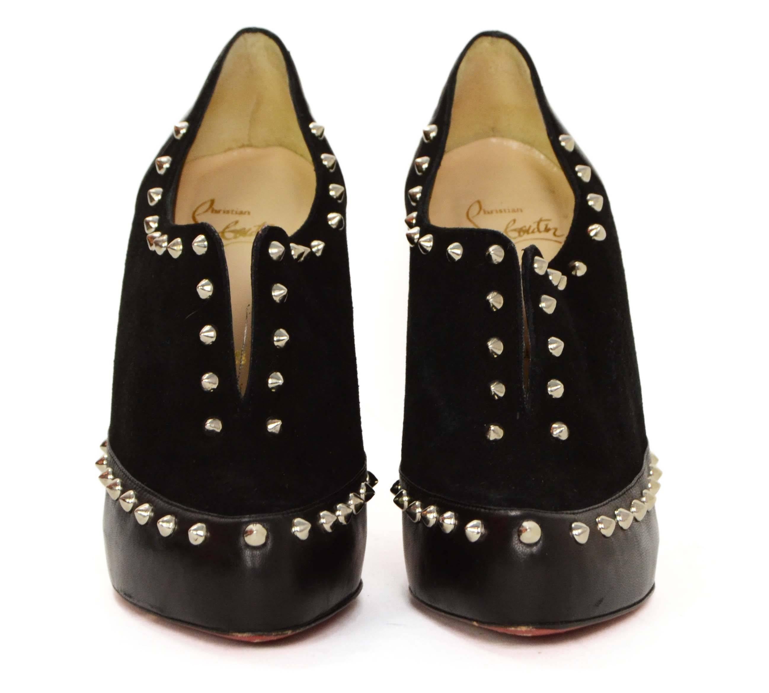 Christian Louboutin Black Suede and Leather Booties With Studs
Features a pointed toe and a slit at the front of the foot

    Made In: Italy

    Color: Black

    Materials: Suede, leather

    Closure/Opening: Slips on over foot

   