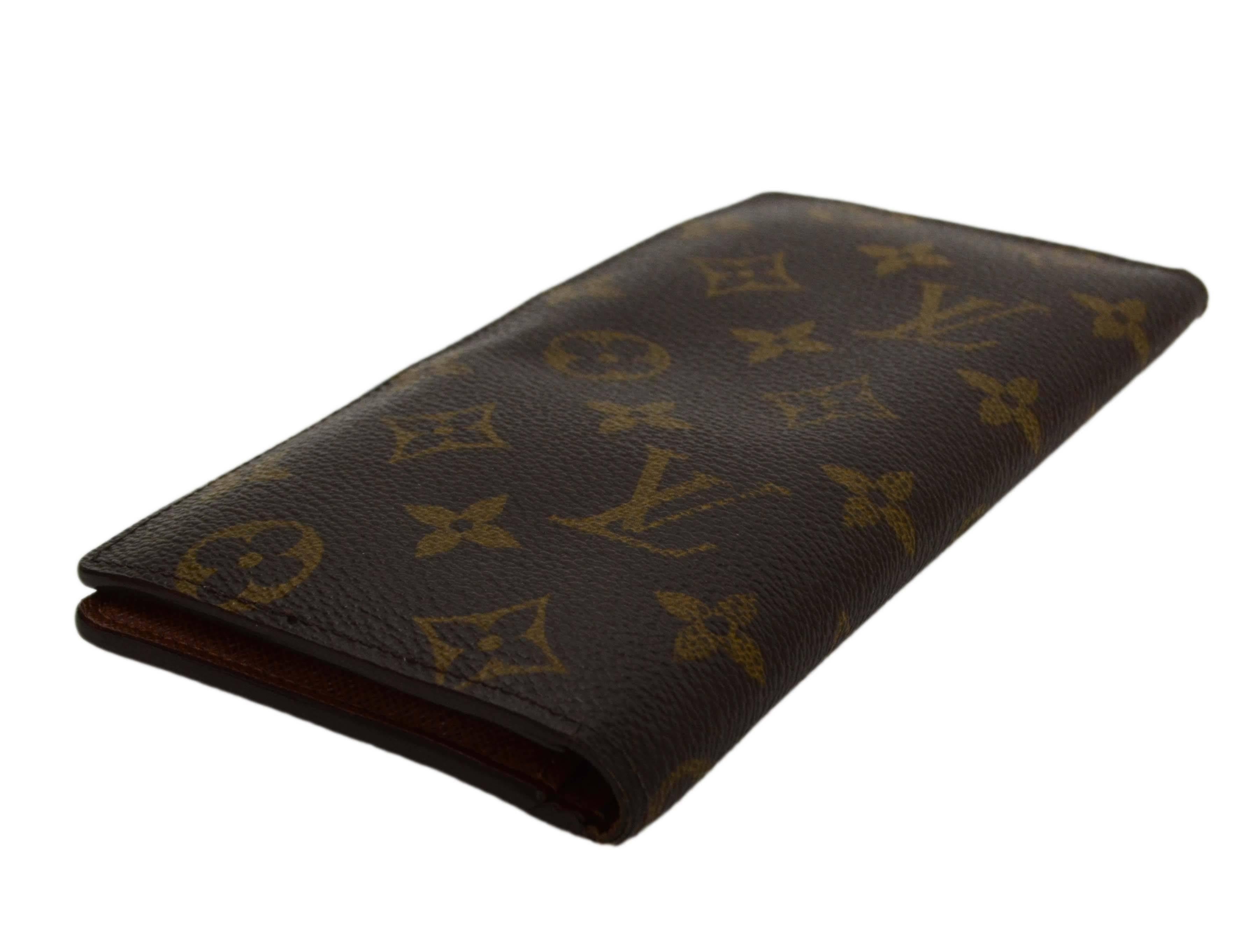 Louis Vuitton Monogram Canvas Vertical Open Wallet 
Made In: France
Year of Production: 2012
Color: Brown
Hardware: None
Materials: Coated canvas
Lining: Brown coated canvas
Closure/Opening: Bifold
Exterior Pockets: None
Interior Pockets: