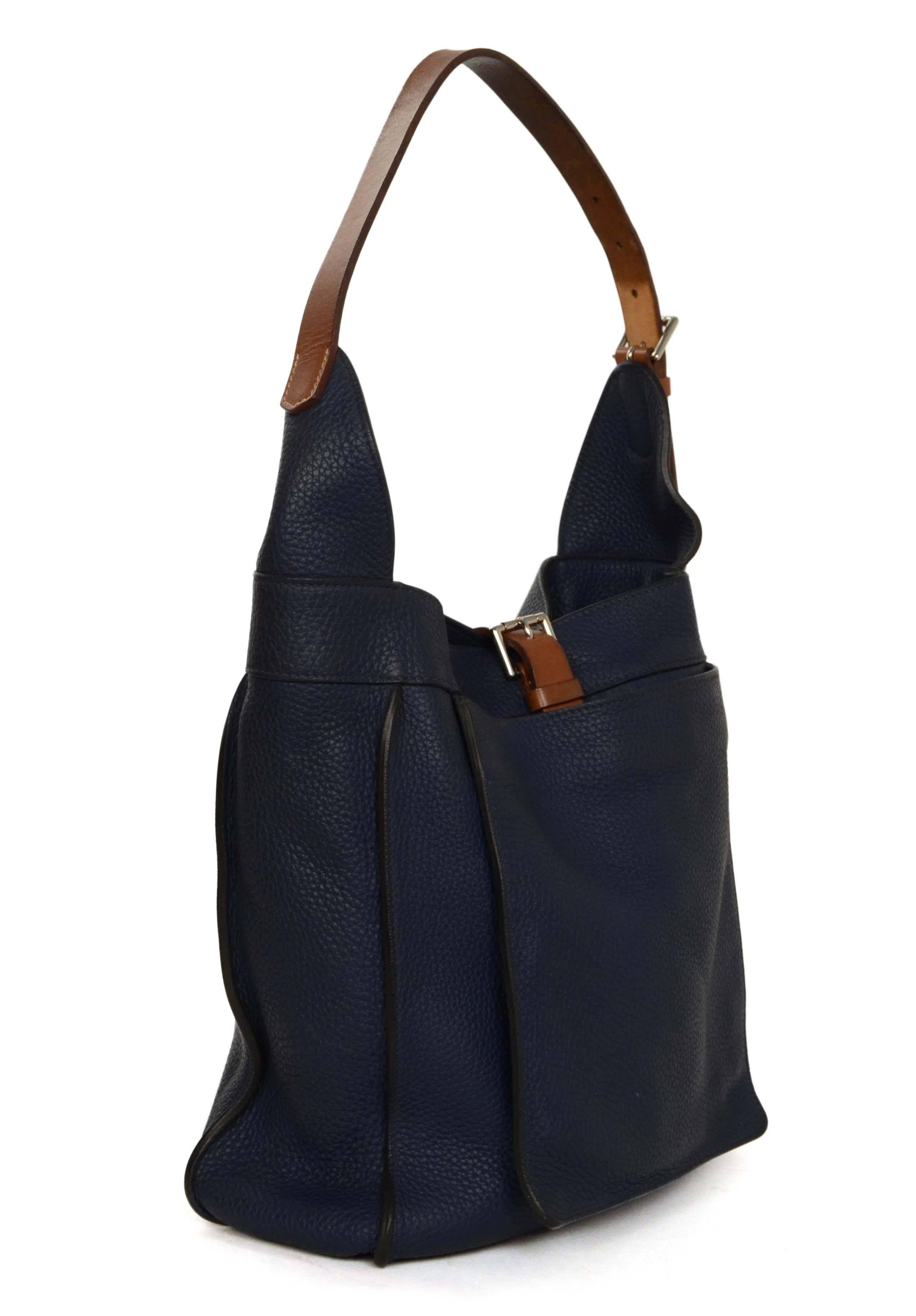 Hermes Navy Clemence 'Marwari' PM Tote 
Features vache hunter leather trim and shoulder strap
Made In: France
Year of Production: 2010
Color: Navy and tan
Hardware: Palladium
Materials: Clemence leather
Lining: Beige canvas
Closure/Opening: