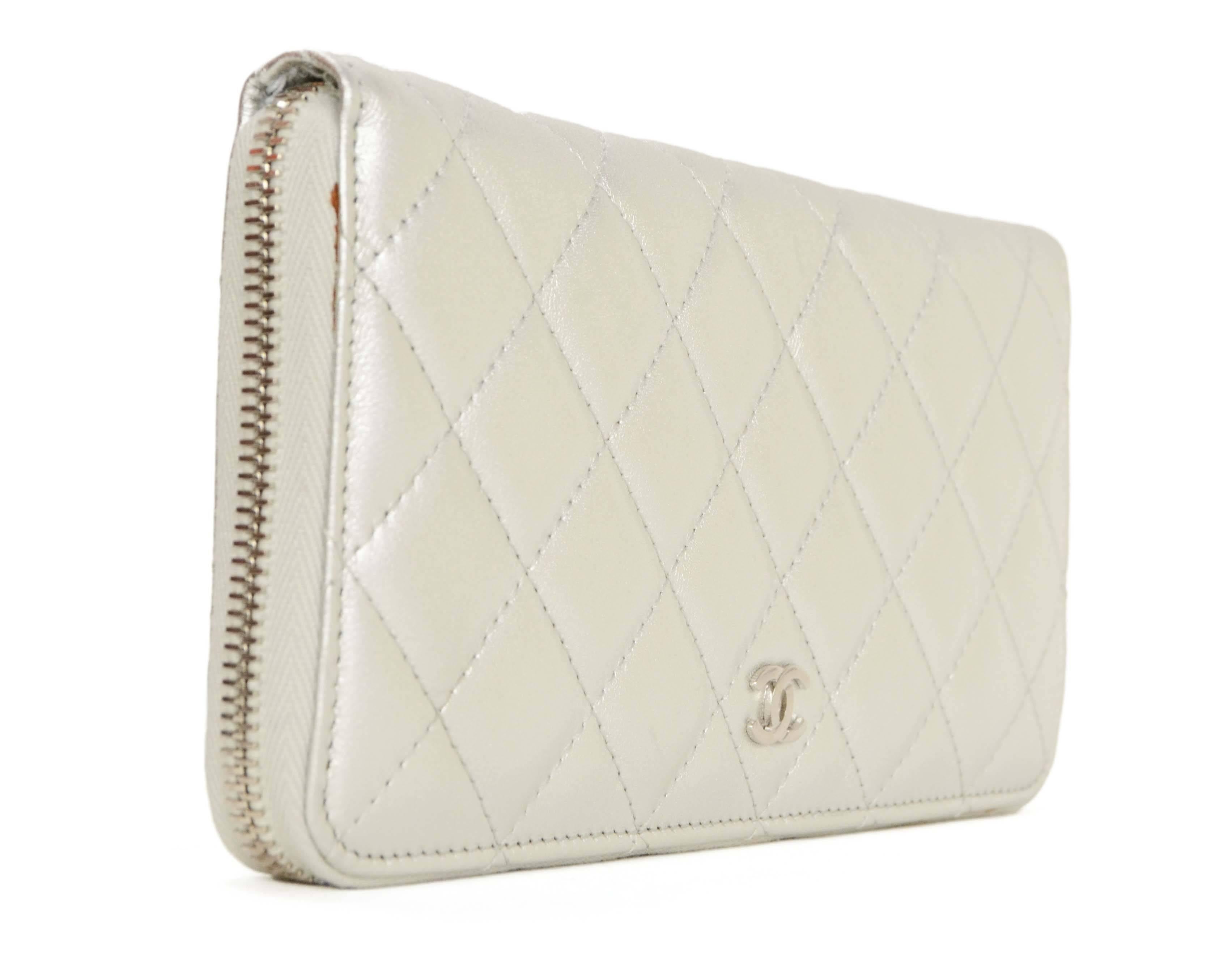 Chanel Silver Quilted Lambskin Zippy Wallet  
Features small silvertone CC on front
Made In: Italy
Year of Production: 2014
Color: Silver
Hardware: Silvertone
Materials: Lambskin
Lining: Grey grosgrain
Closure/Opening: Zip around