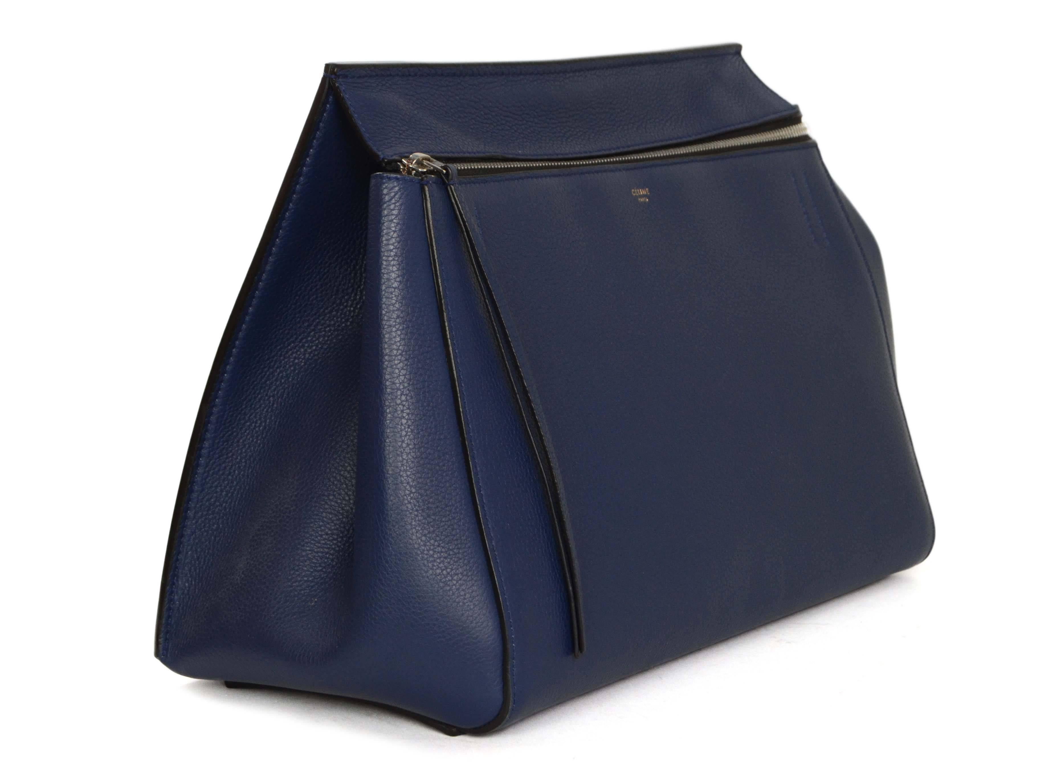 Celine Blue Leather Medium Edge Tote
Made In: Italy
Color: Blue
Hardware: Silvertone
Materials: Leather
Lining: Black leather
Closure/Opening: Zip across top
Exterior Pockets: Back patch pocket with snap button closure
Interior Pockets: One