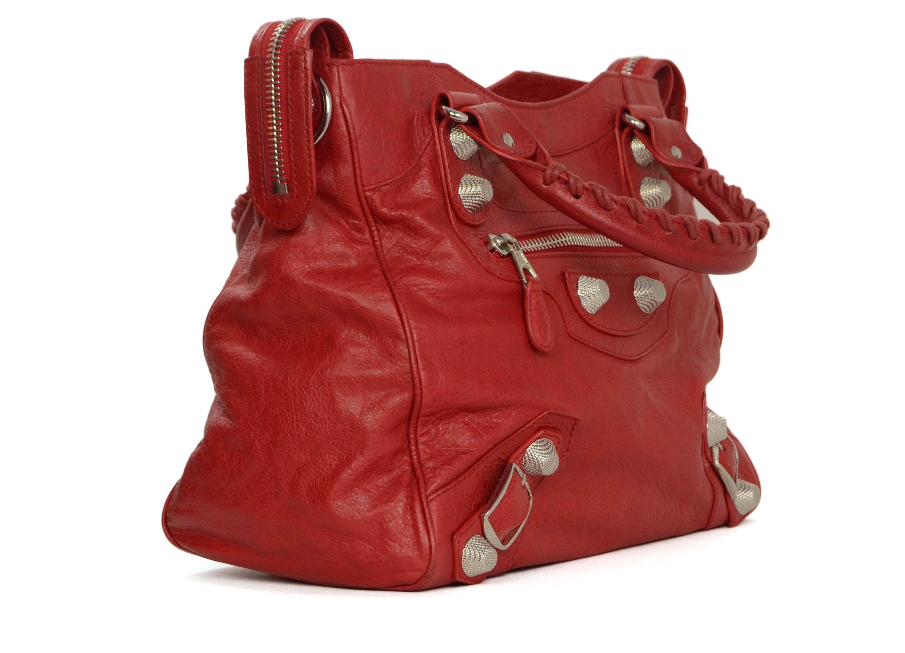 Balenciaga Red Distressed Leather Giant 21 Velo Bag 
Features optional crossbody strap
Made In: Italy
Color: Red
Hardware: Silvertone
Materials: Distressed leather and metal
Lining: Black canvas
Closure/Opening: Double zip across