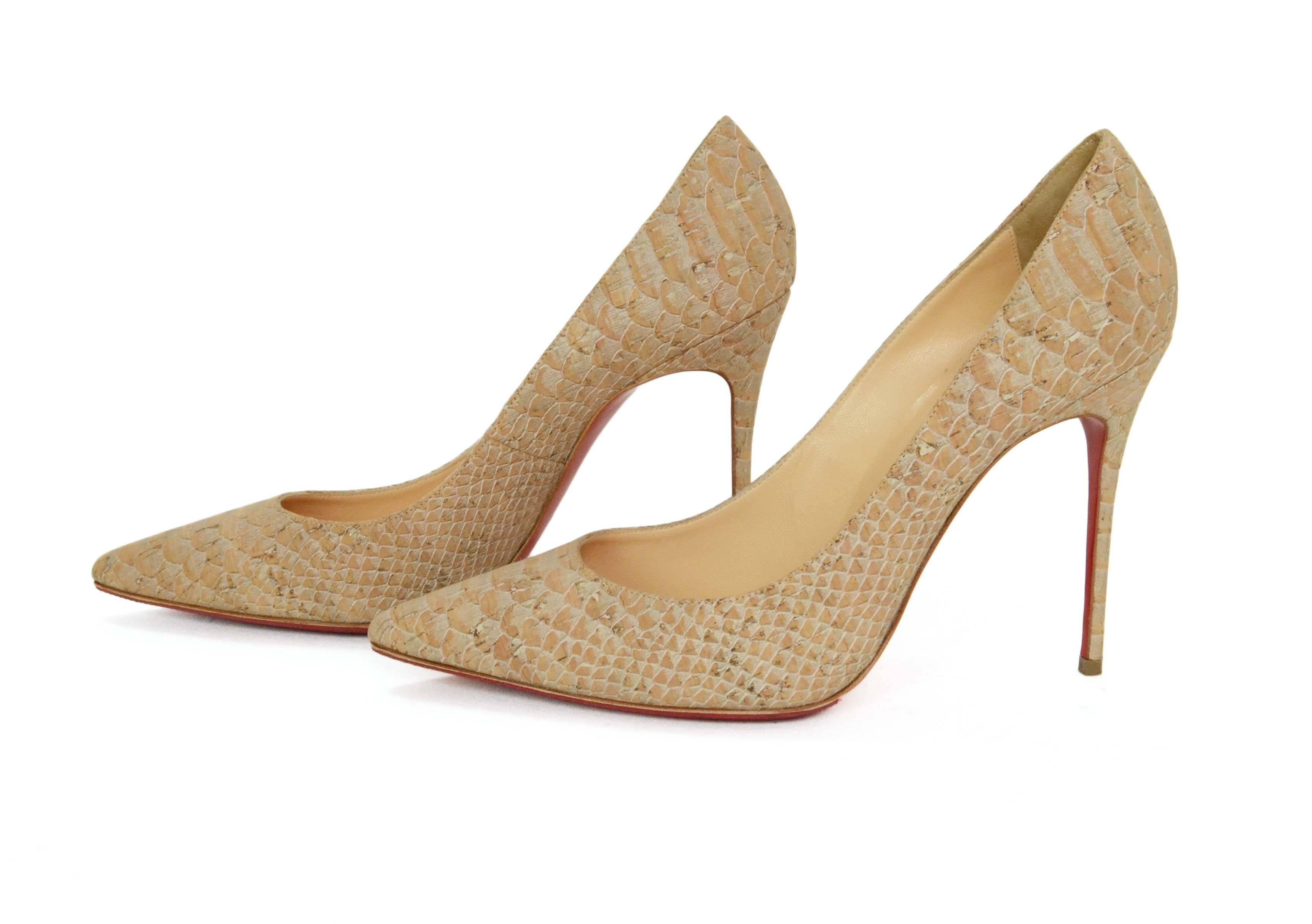 Christian Louboutin Tan Python Printed Cork 'Decollete' Pumps 
Features a light metallic/shimmer overlay on python printed cork
Made In: Italy
Color: Tan
Materials: Cork
Closure/Opening: Slide on
Sole Stamp: Christian Louboutin Made in Italy