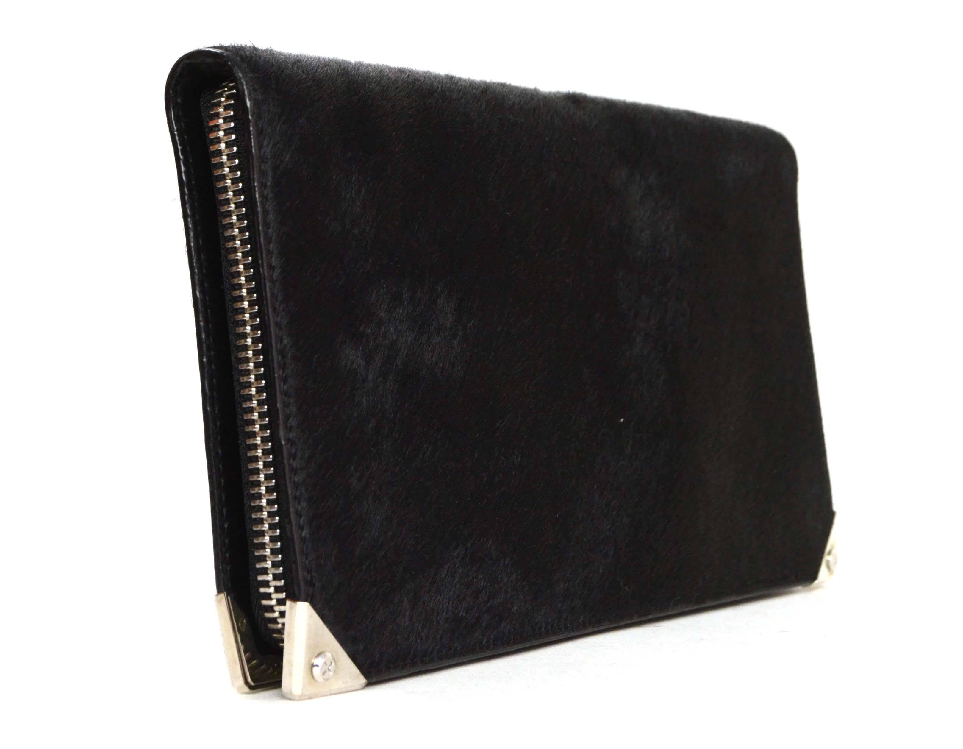 Alexander Wang Black Calfskin Prisma Clutch 
Features oversized silvertone hardware
Made In: China
Color: Black
Hardware: Silvertone
Materials: Calfskin and metal
Lining: Black leather
Closure/Opening: Bi-fold with zip around